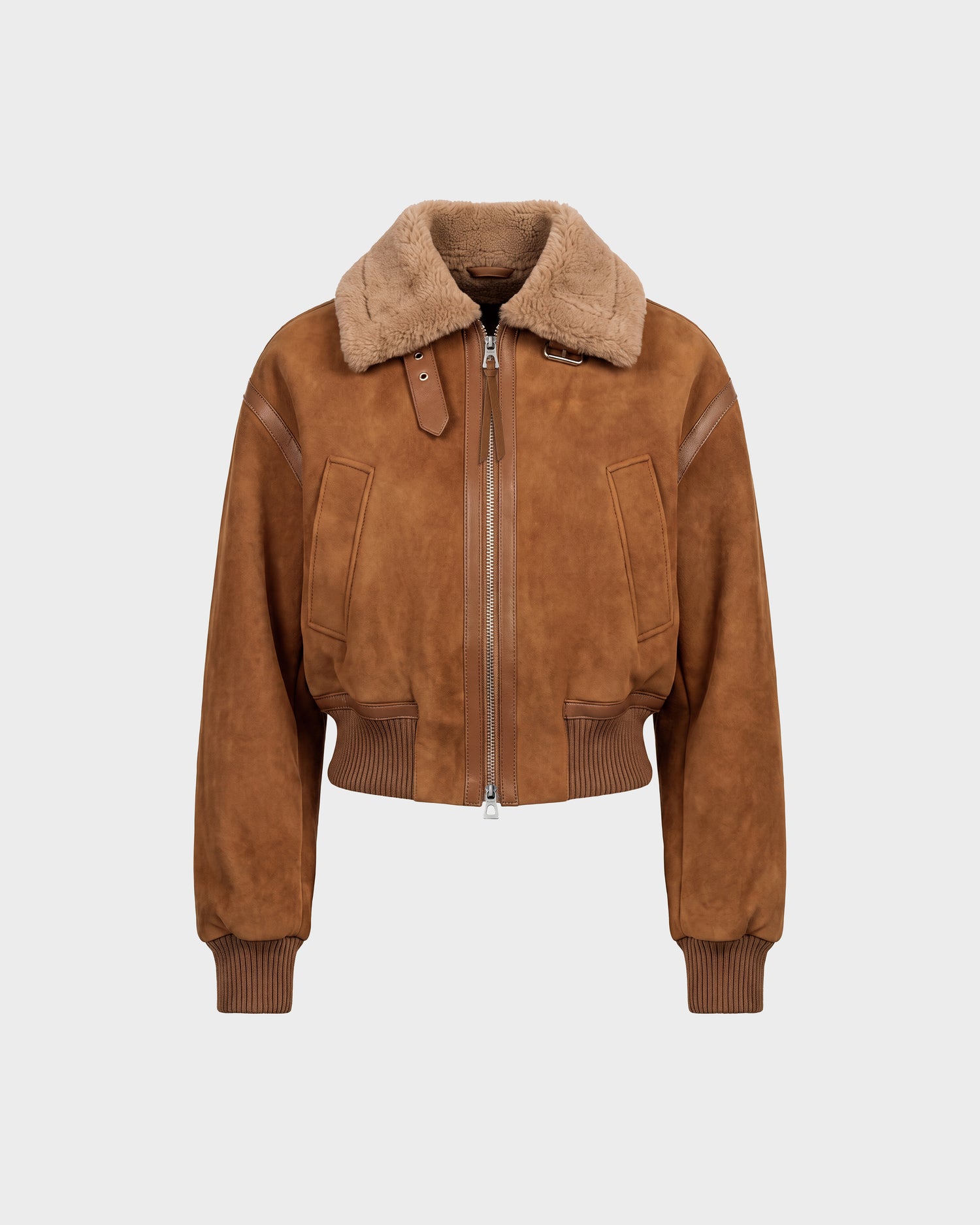 The LIZZIE - 8126787 Tan bomber jacket by Rudsak is crafted from soft brown suede and features a wide tan shearling collar, zip closure, front pockets, and ribbed cuffs and hem for a luxurious feel. This stylish shearling jacket offers a slightly cropped fit and is showcased against a plain light gray background.