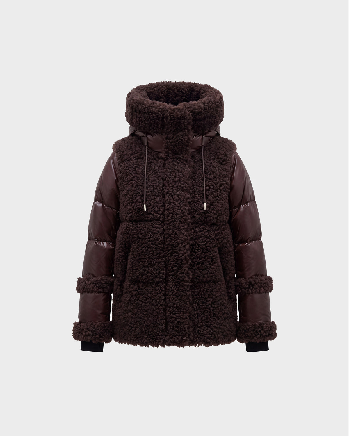 A women’s winter jacket, the MARISSA - 8126728 Espresso by Rudsak, in dark brown features a plush sherpa-textured body paired with smooth, quilted down sleeves. The design includes a high collar, drawstrings, and large front pockets. It is photographed against a plain light gray background.