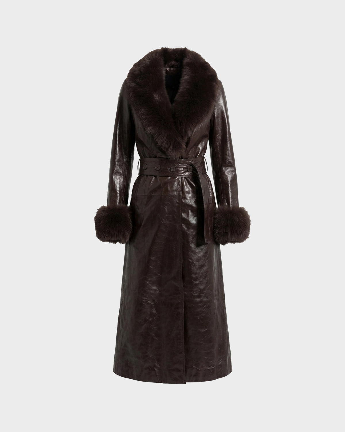 The VIVIANNE - 8126933 Espresso by Rudsak is a dark brown, long leather trench coat with a faux fur collar and fur-trimmed cuffs, featuring a wrap-front design and belted waist, displayed against a plain light background.