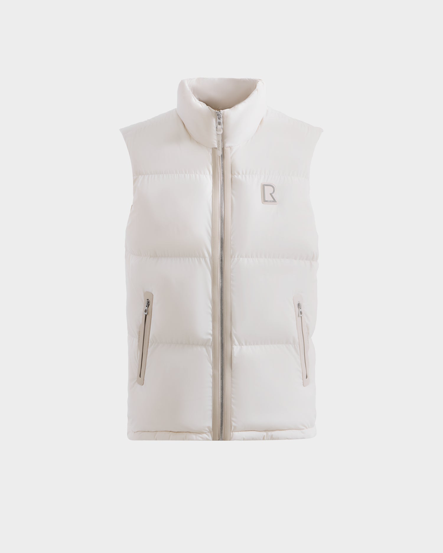 The Rudsak FREDDY - 6125571 Vanilla is a sleeveless white men’s puffer vest with a high collar, front zipper, two zippered side pockets, and a subtle left chest logo, perfect for lightweight layering, shown on a plain white background.