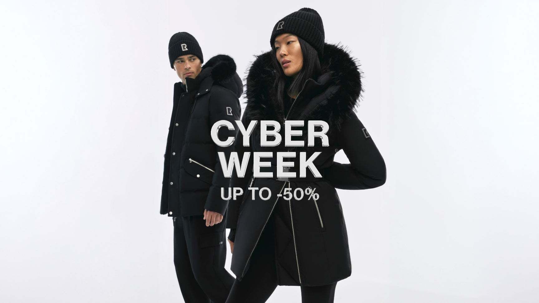 Two people wearing black winter coats with 'CYBER WEEK UP TO 50%' text overlay on a white background.
