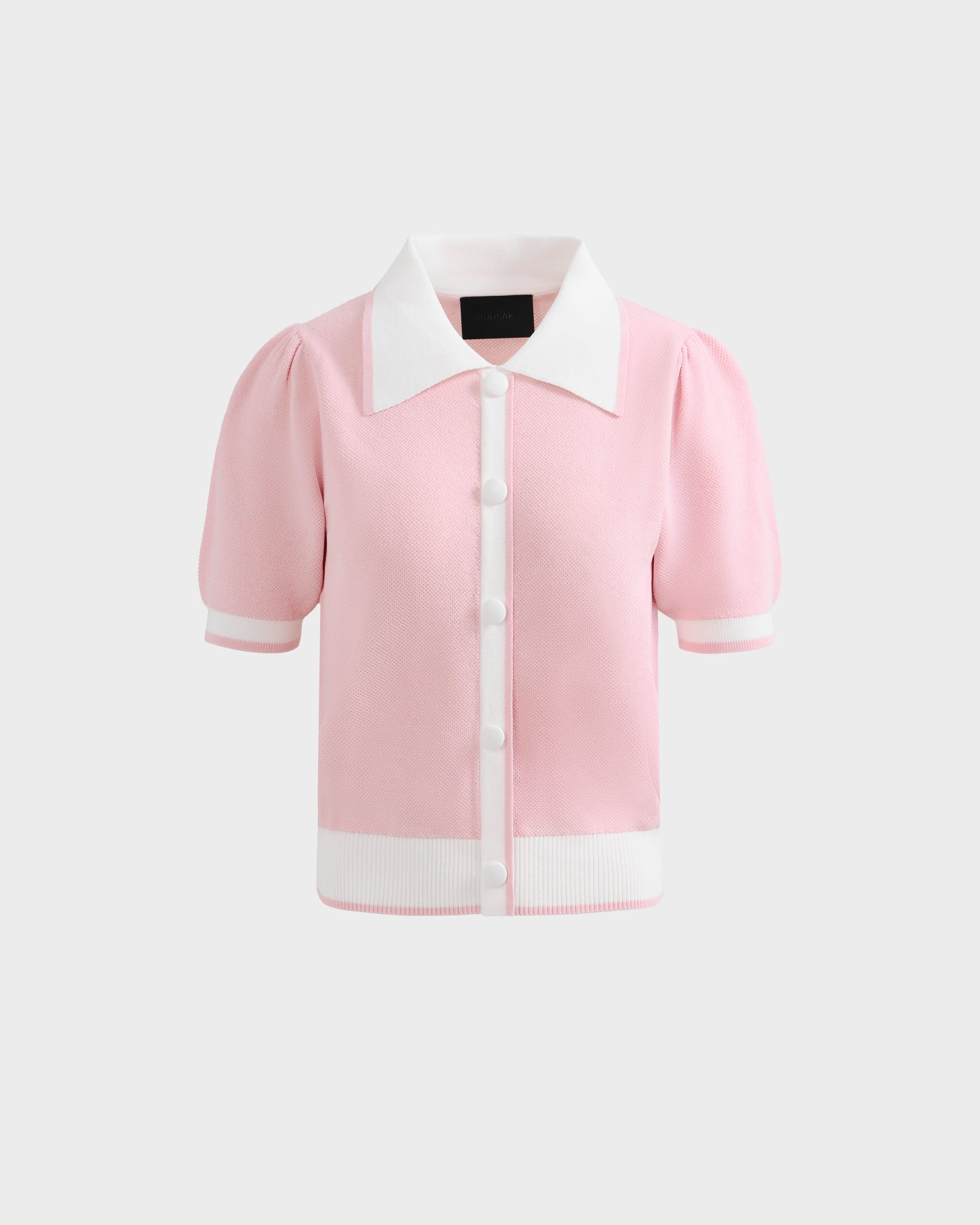 The IRIS - 8526012 Pink knit short-sleeve sweater by Rudsak features a contrast collar, white buttons, and crisp white trim at the cuffs and hem. Shown against a plain white background for a fresh look.