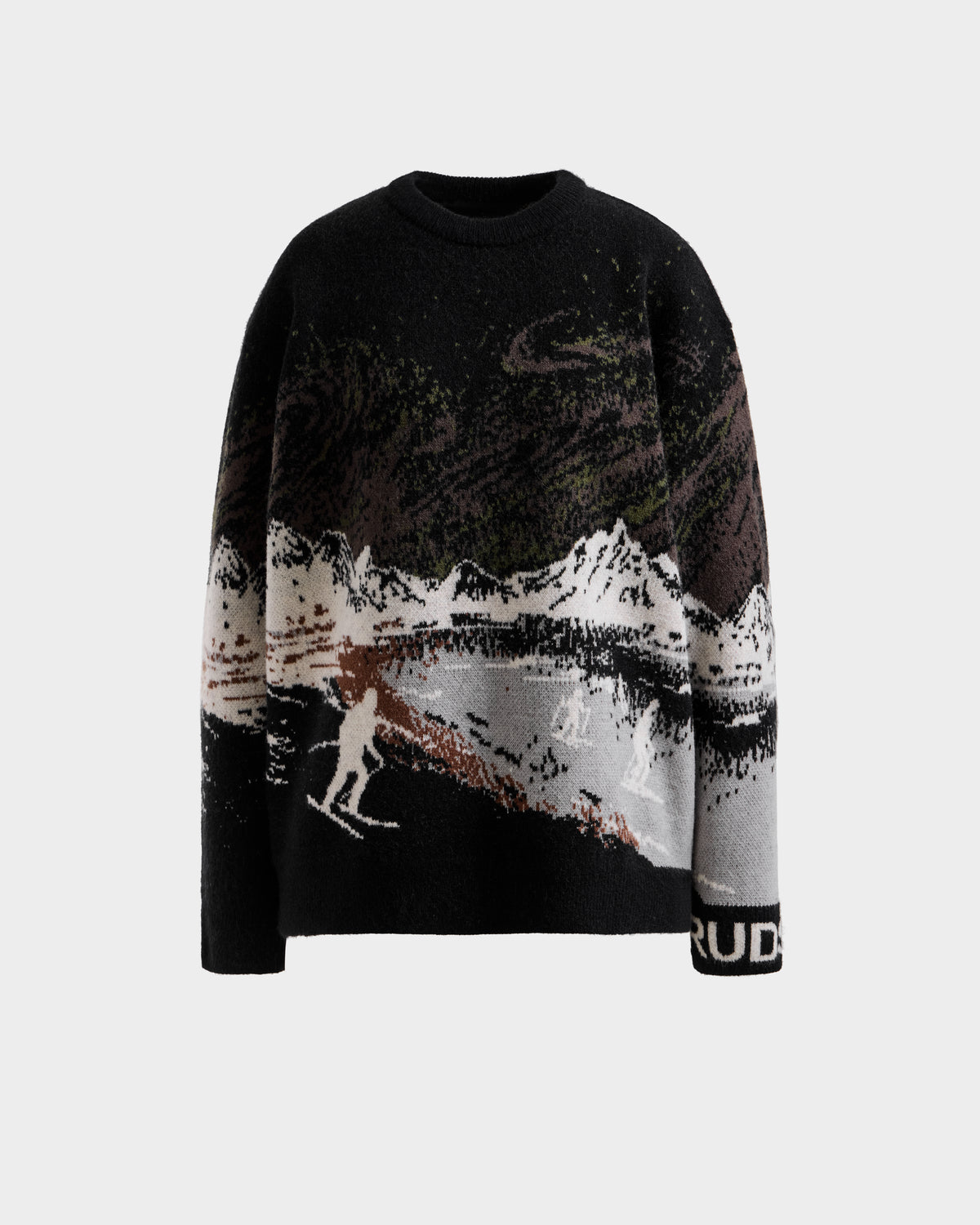 The Rudsak IZZY - 9525557 Black W is a unisex knit sweater with a ski mountain motif, snowy scenes, skiers, and "RUD" on the left cuff—ideal for après-ski events.