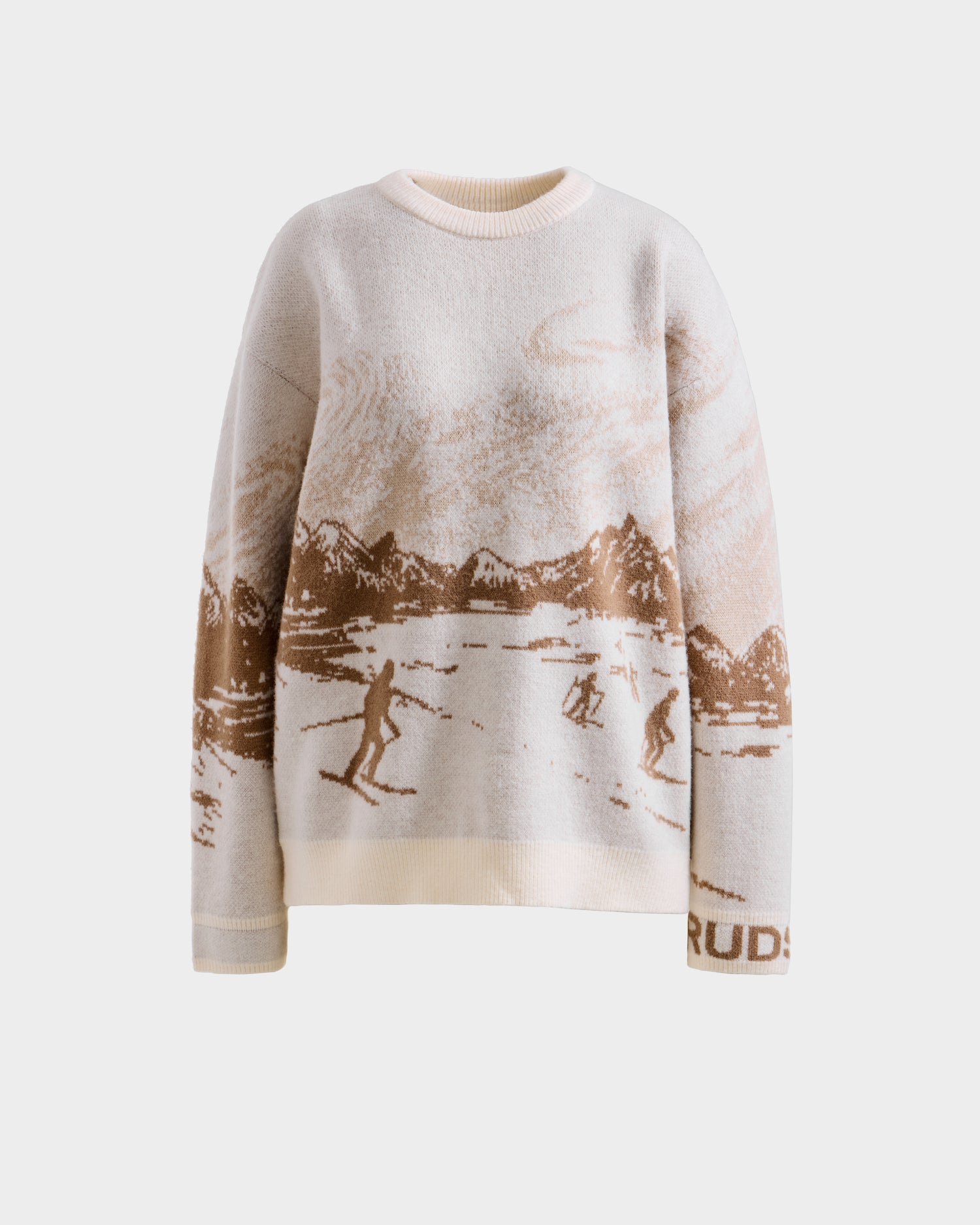 The Rudsak IZZY - 9525557 Iceland W is a cream unisex knit sweater with a brown alpine skiing scene, mountain and cloud pattern, and "RUD" on the sleeve—ideal for après-ski style.
