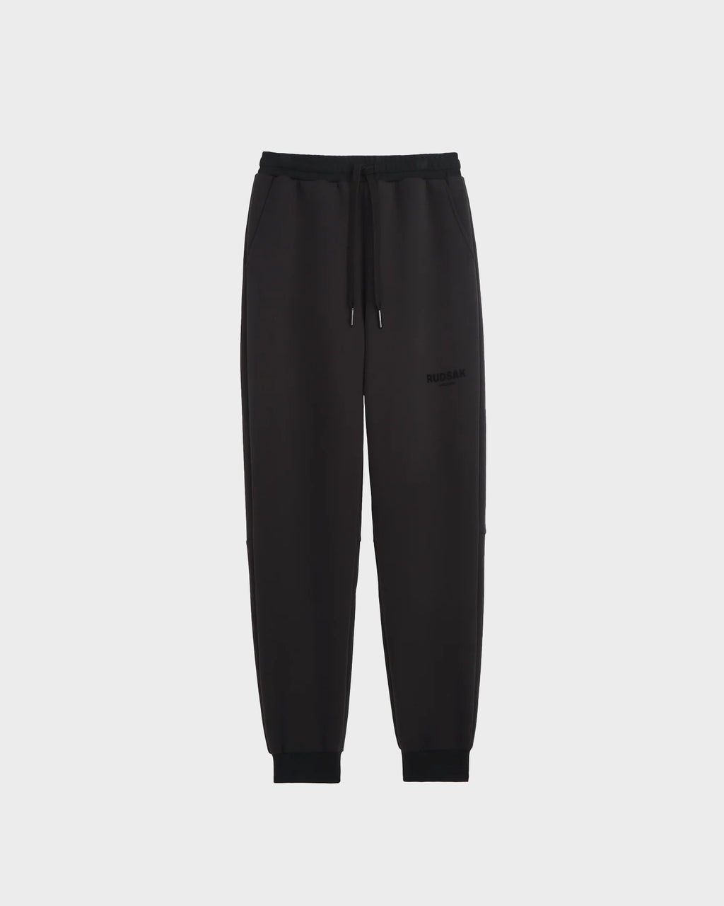 The JOSS - 9524009 Black M joggers by Rudsak feature premium cotton, an elastic waistband, drawstring, side pockets, and cuffed ankles. Shown on a plain light gray background for a sleek, modern look.