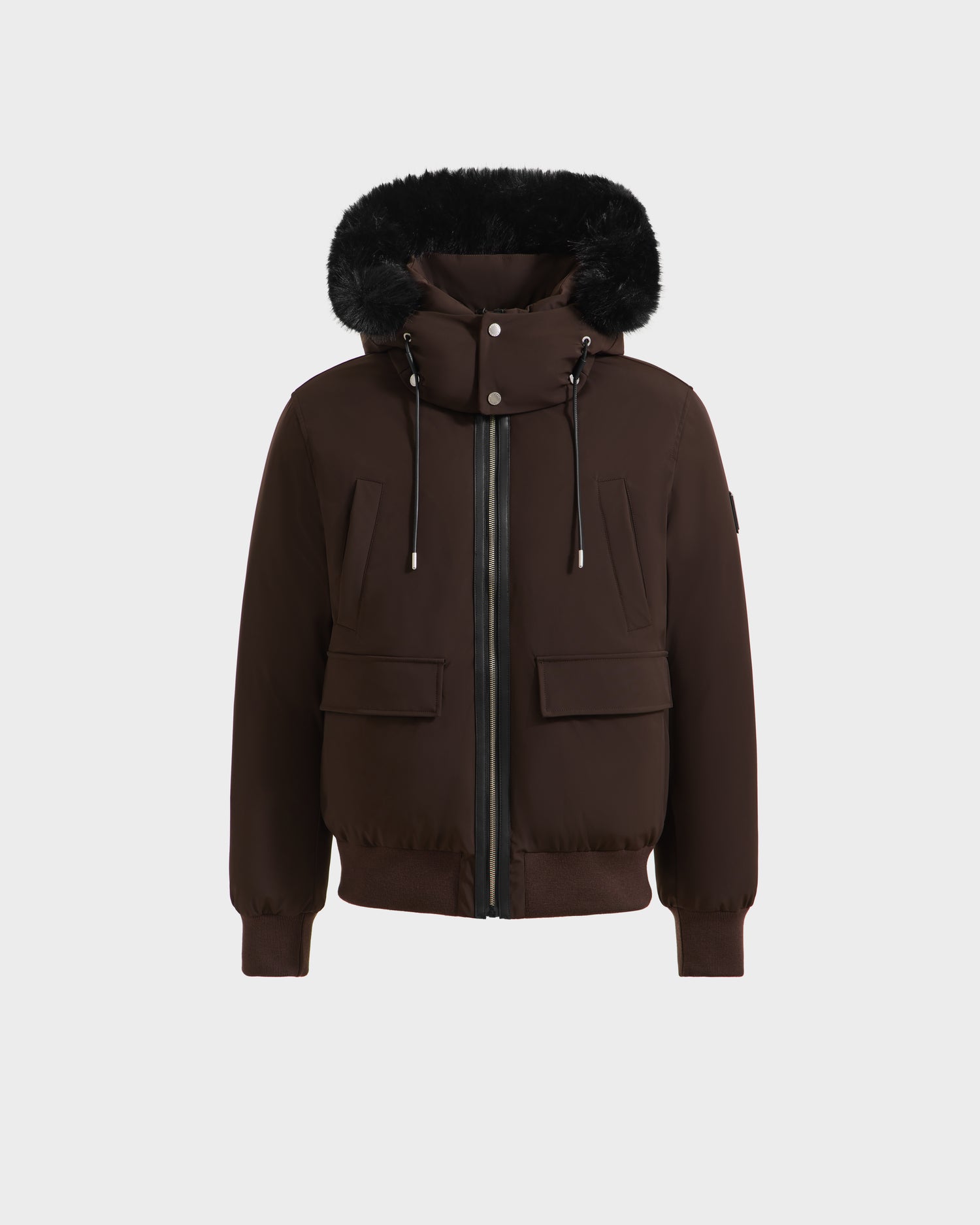 The Rudsak JEROME - 6125514 Espresso men’s down bomber jacket in brown features a black fur trim, front zipper, snap buttons, two flap pockets, ribbed cuffs and hem, and is crafted with RDS-certified down for reliable winter warmth.