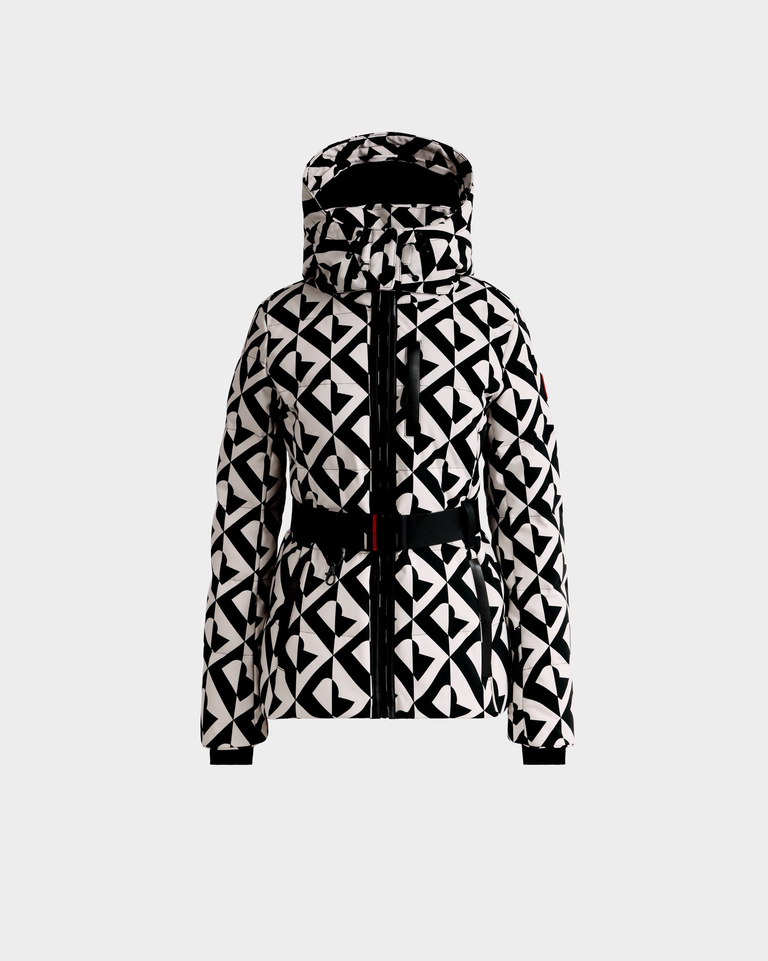 The Rudsak JOANNA P - 8125623 Vanilla Monogram jacket features a black and white geometric pattern, hood, front zipper, long sleeves, and a belted waist. Available for pre-order; ships by November 30th. Displayed on white background.