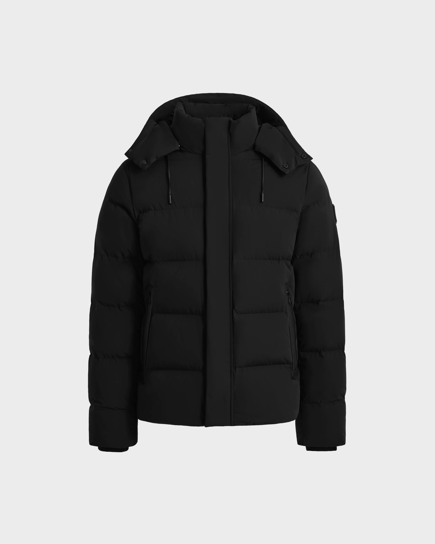 The Rudsak JOEL - 6124605 Black men’s puffer jacket features a hood, front zipper, two side pockets, and quilted design for reliable cold-weather performance. Stylish and functional, its shown on a plain white background.