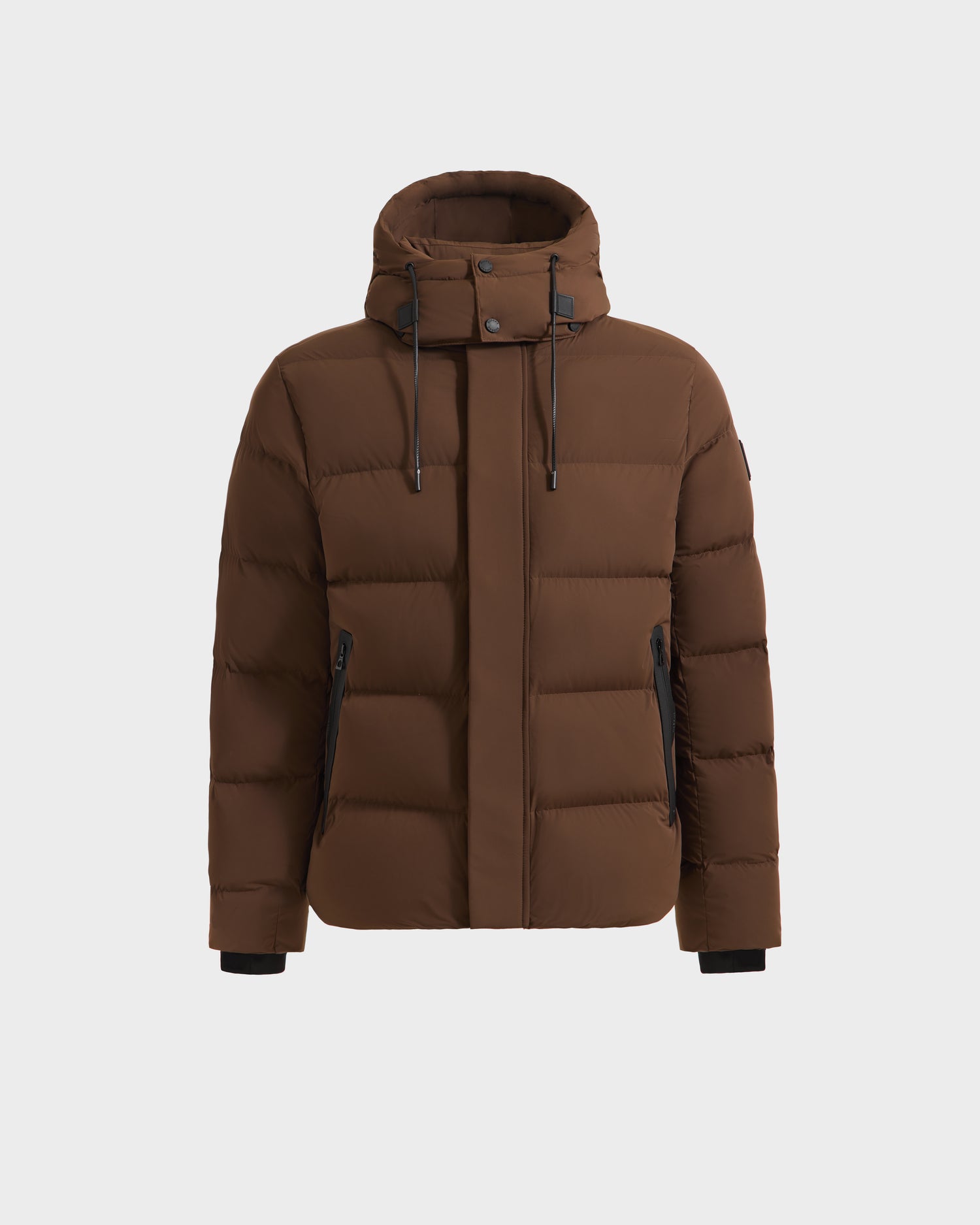The Rudsak JOEL - 6124605 Mocha is a mens brown puffer jacket with a hood, front zipper, snap-button placket, black zipper pockets, and wrist cuffs, designed for cold weather and shown on a plain white background.