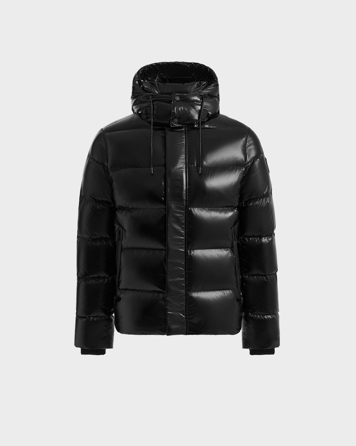The JOEL S - 6124606 Black by Rudsak is a shiny black premium down puffer jacket with a hood, front zipper, and snap closures, shown on a light grey background—ideal stylish winter outerwear to keep you warm.