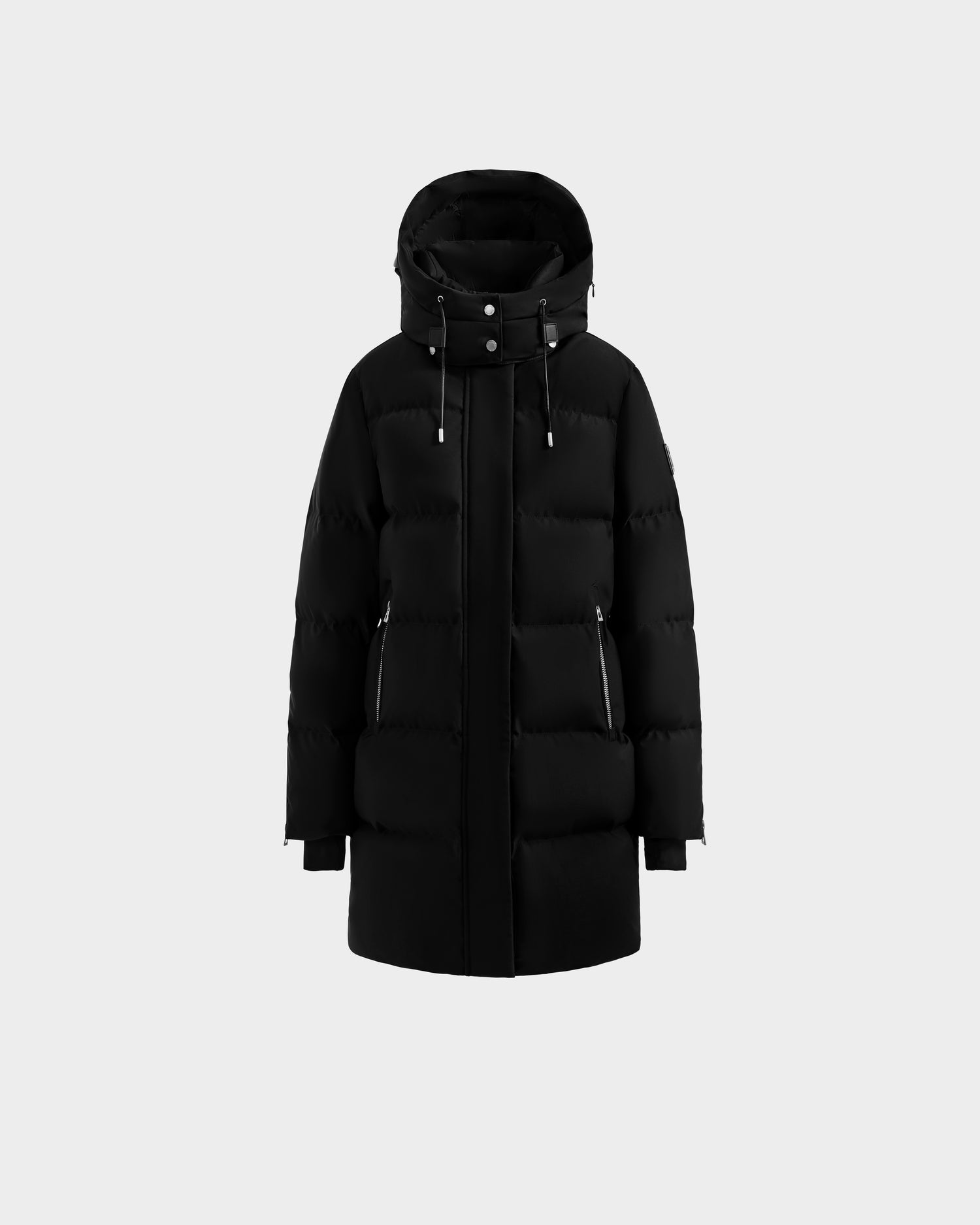 The Rudsak JOELLE H - 8125602 Black is a women’s black, hooded down puffer jacket with a front zipper, snap buttons, and two zippered side pockets, water-resistant, shown on a plain light gray background.