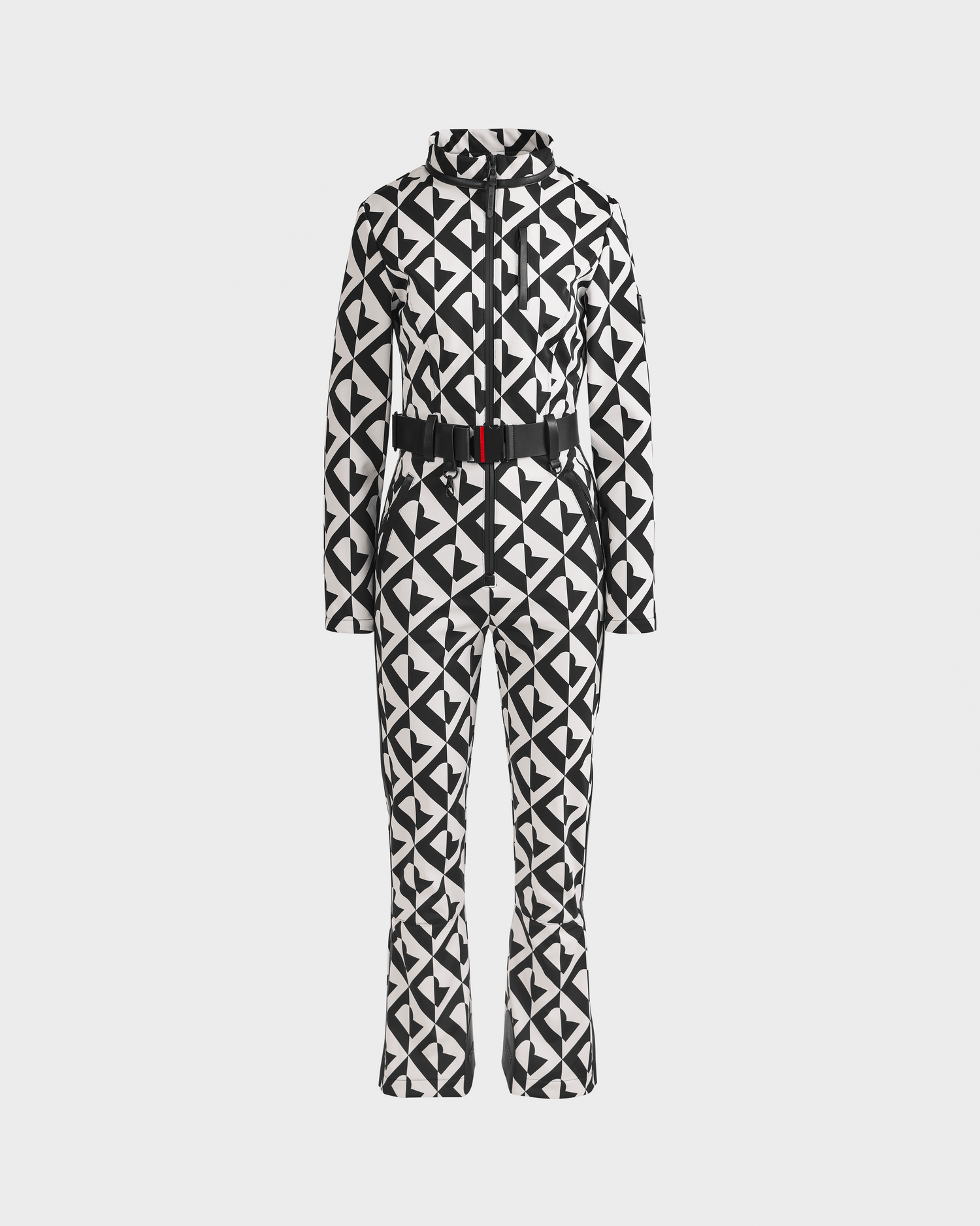 The JOSIE - 8124817 Vanilla Monogram by Rudsak is a black and white geometric one-piece ski suit with a front zipper, high collar, long sleeves, flared legs, and a black waist belt, shown on a plain white background.