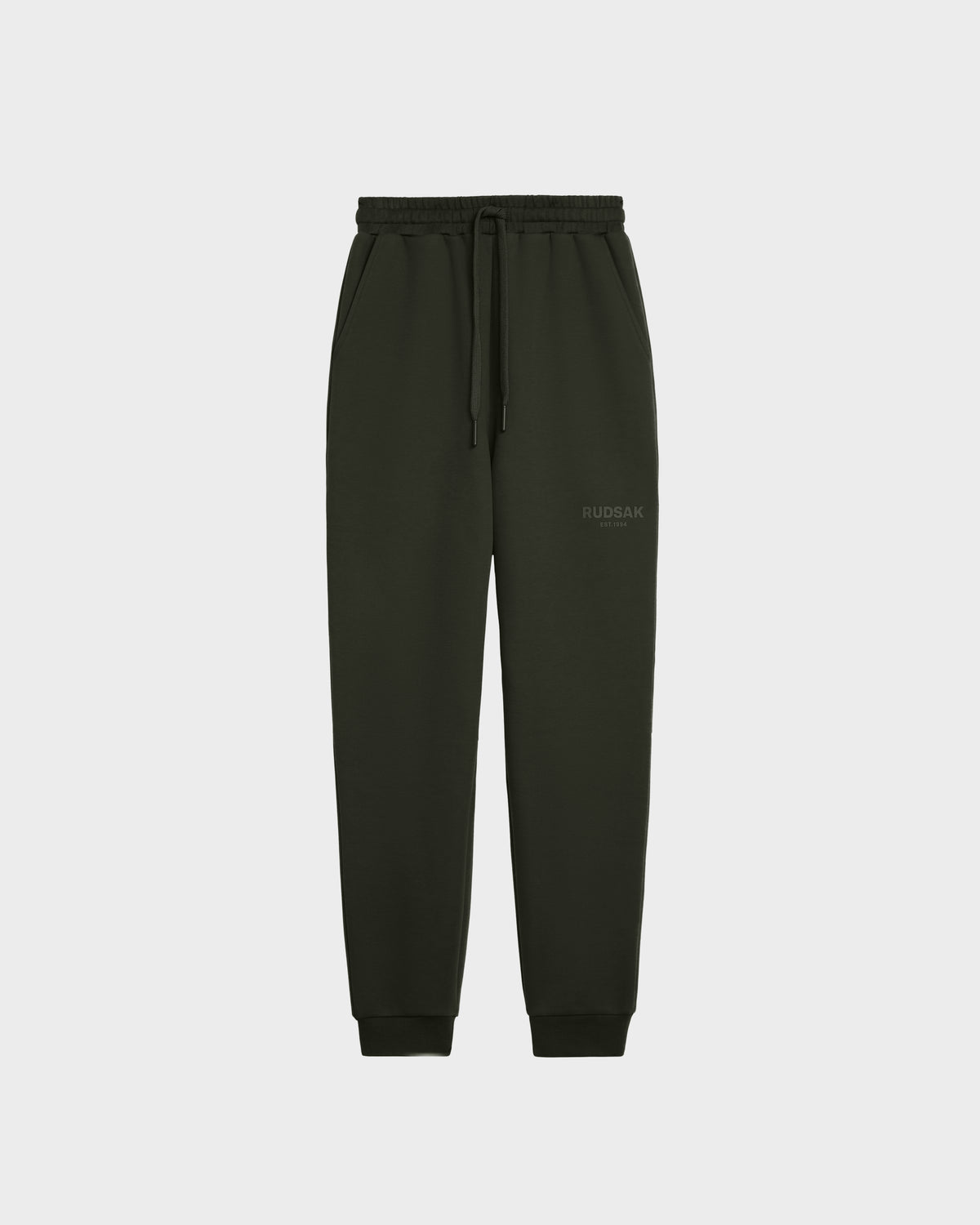 The Rudsak JOSS - 9524009 joggers in dark olive (size M) feature premium cotton, an elastic waistband with drawstring, side pockets, cuffed ankles, and a subtle logo on the upper left thigh, shown against a plain white background.