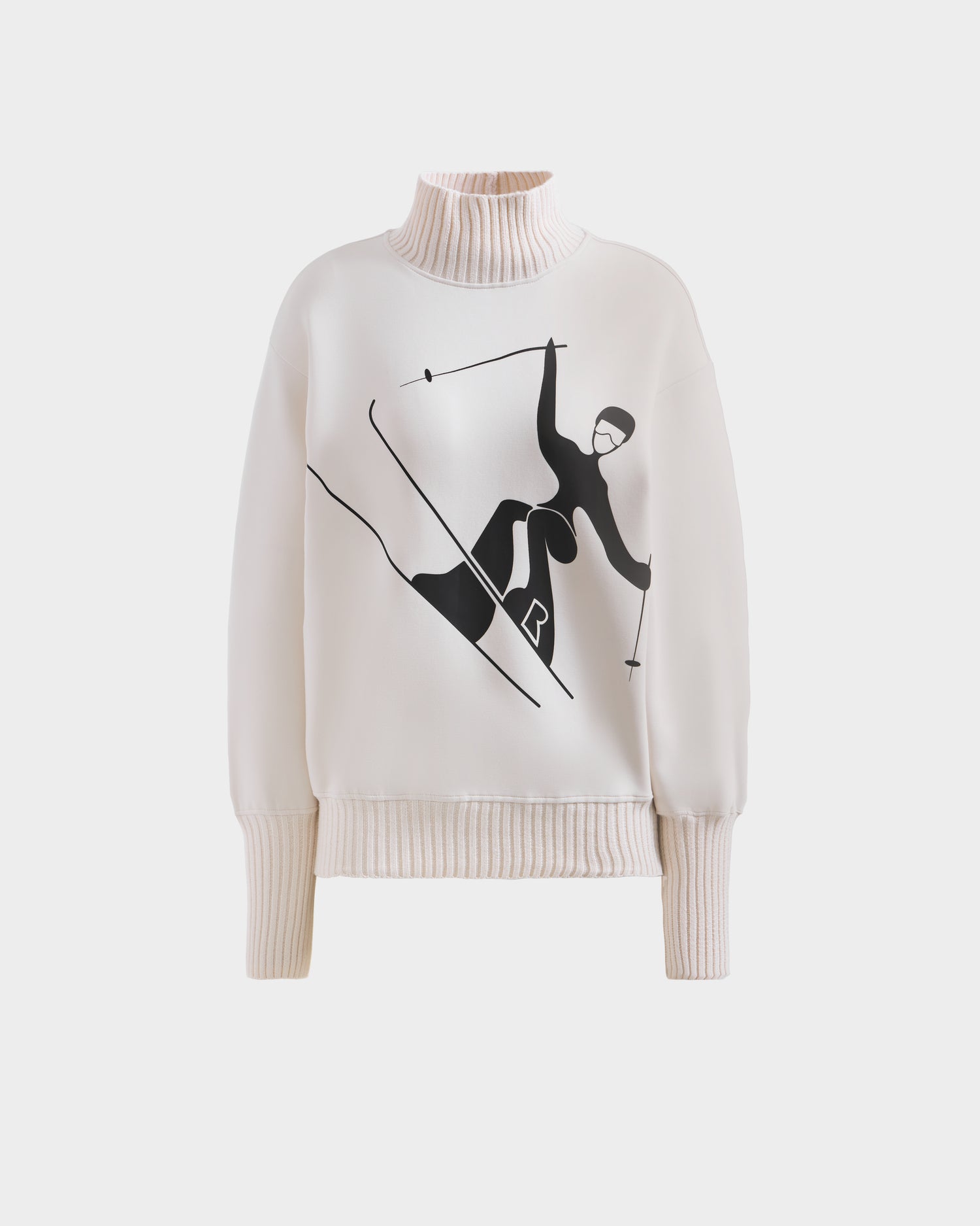 The Rudsak JOYCE - 8525647 Vanilla is a cream women’s ski sweater with ribbed cuffs and hem, featuring a bold black skier graphic on the front for a chic après-ski style.