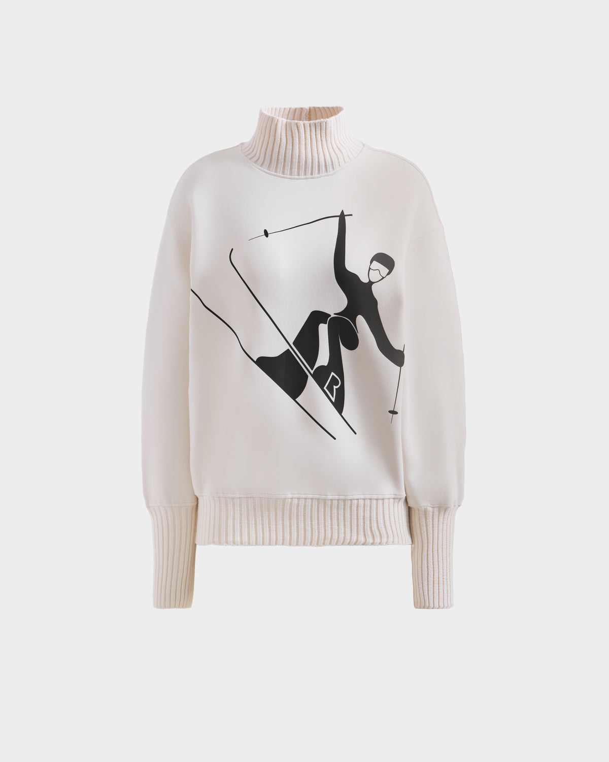 The Rudsak JOYCE - 8525647 Vanilla is a cream women’s ski sweater with ribbed cuffs and hem, featuring a bold black skier graphic on the front for a chic après-ski style.