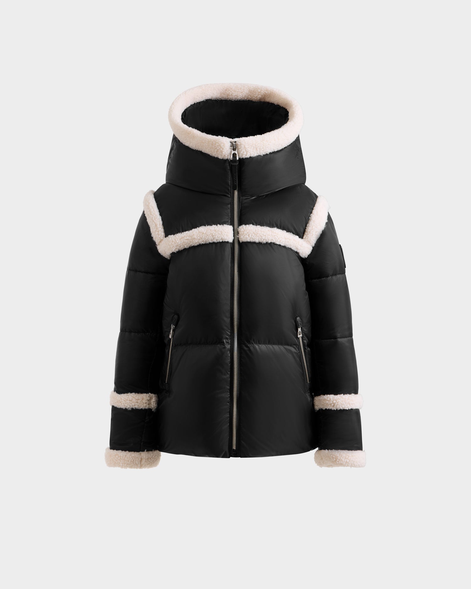 The JULIANA K - K125550 Black puffer jacket by Rudsak features a hood with white faux fur trim on the hood, chest, cuffs, and hem, plus a front zipper and zippered pockets. Displayed against a plain light background.