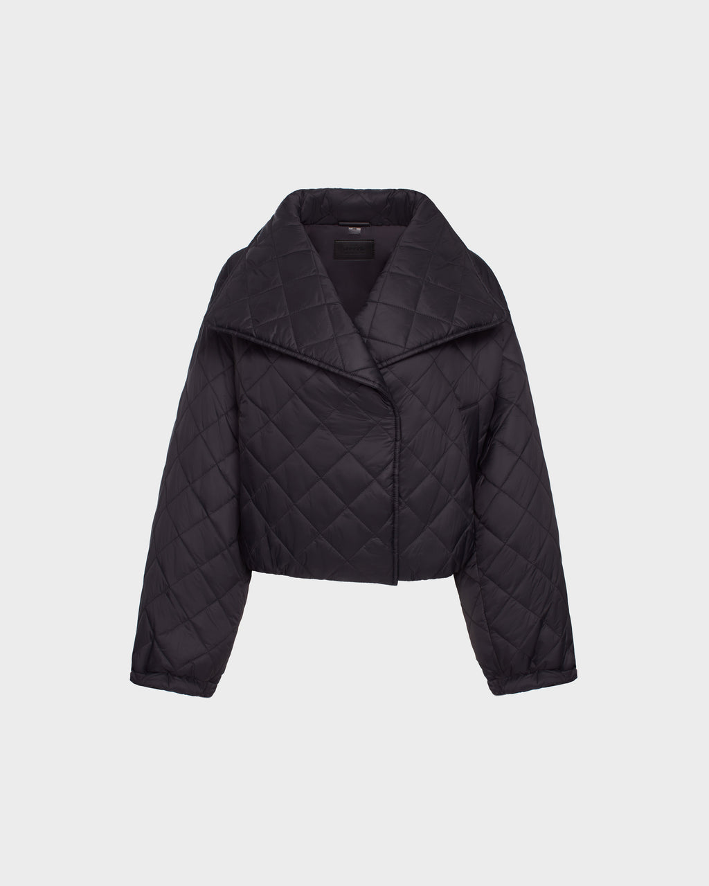 The Rudsak KALEE - 8124005 Black is a womens cropped quilted light jacket with long sleeves, a wide collar, and an asymmetrical front closure, shown against a plain white background.