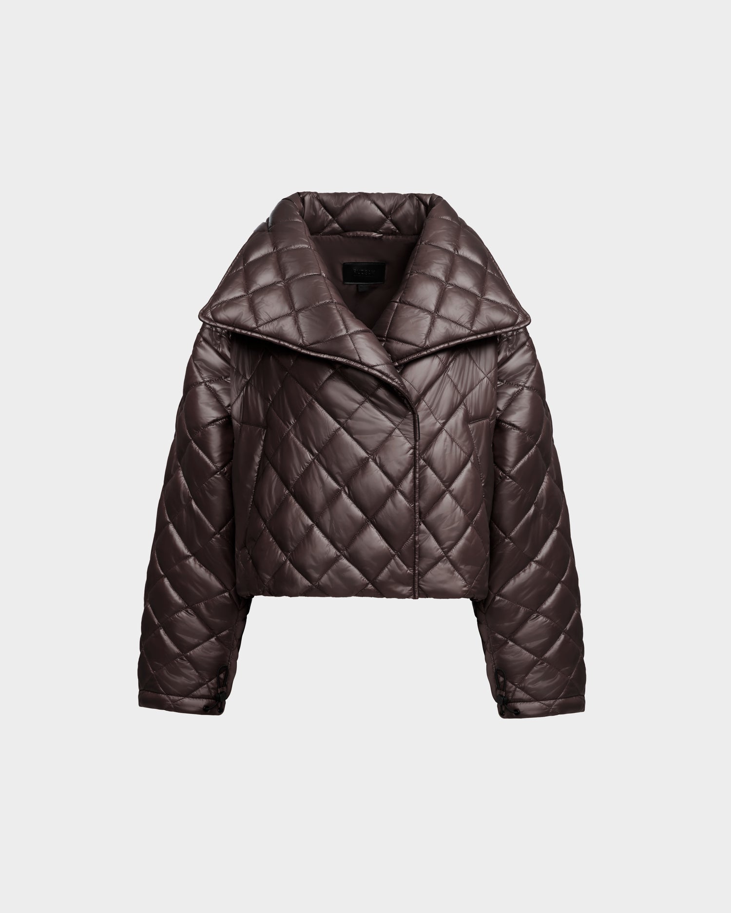 KALEE - 8124005 Espresso by Rudsak is a dark brown, quilted puffer jacket featuring a wide collar, long sleeves, and a short, boxy fit. Designed as a women's cropped jacket with a diamond stitch pattern and front closure for active versatility, it is displayed on a plain light gray background.