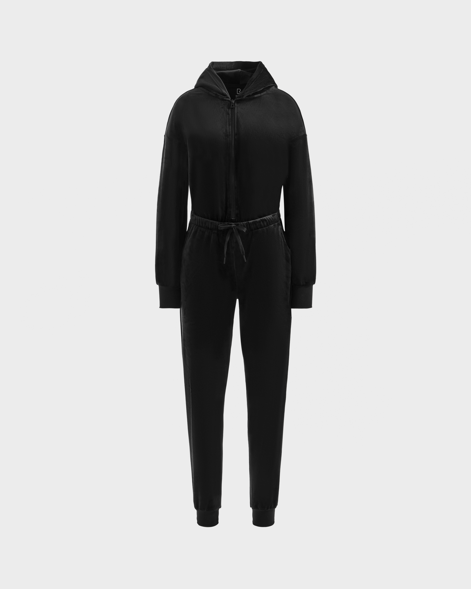 The Rudsak KETZY - L525503 Black is a women’s black velour hooded jumper with long sleeves, zip-up front, drawstring waist, and fitted cuffs, shown on a plain light gray background.
