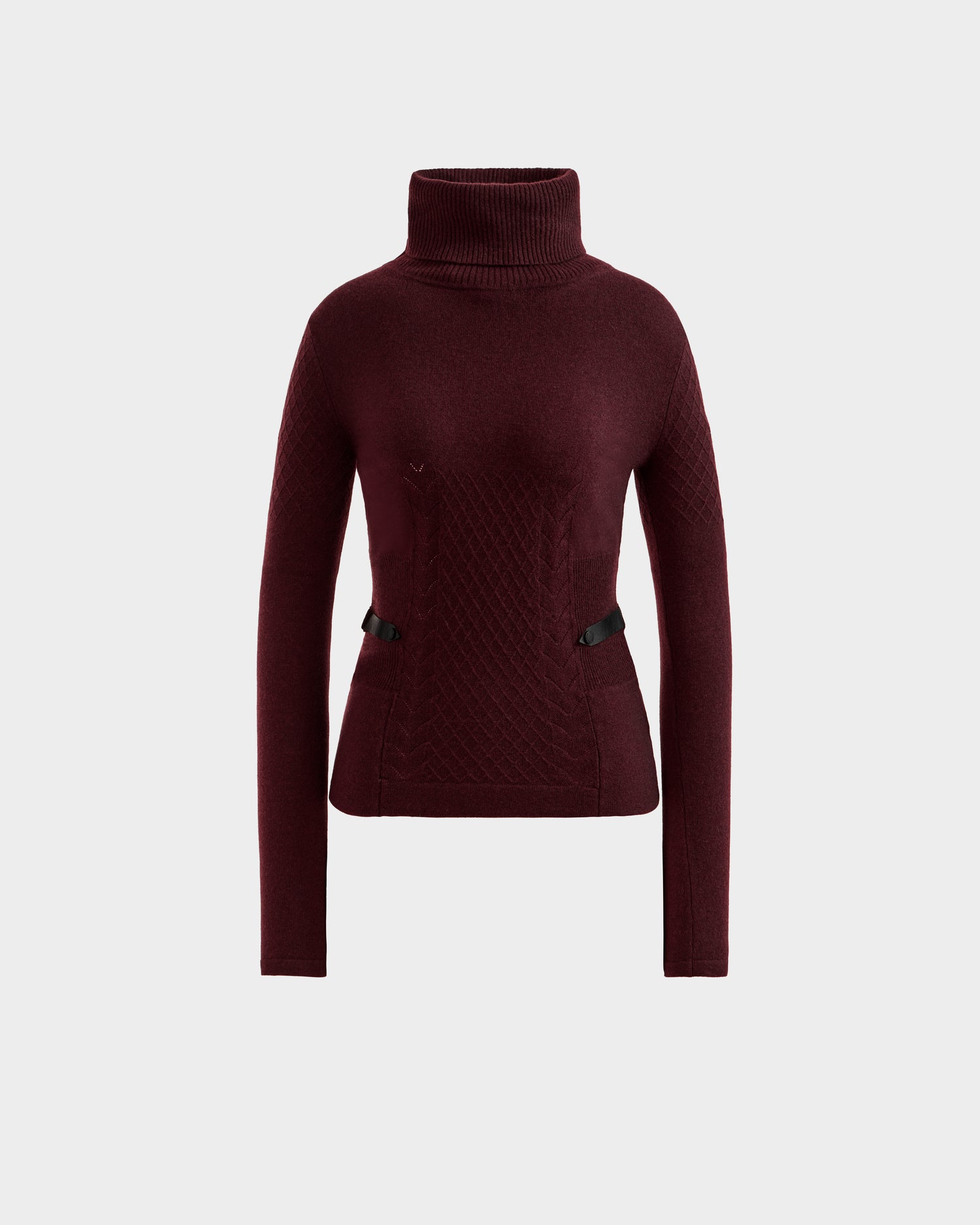 The LAURA - 8524596 Bordeaux by Rudsak is a women’s burgundy knit turtleneck sweater with long sleeves, a fitted waist, textured patterns, and two small black vegan leather waist trims, shown against a white background.