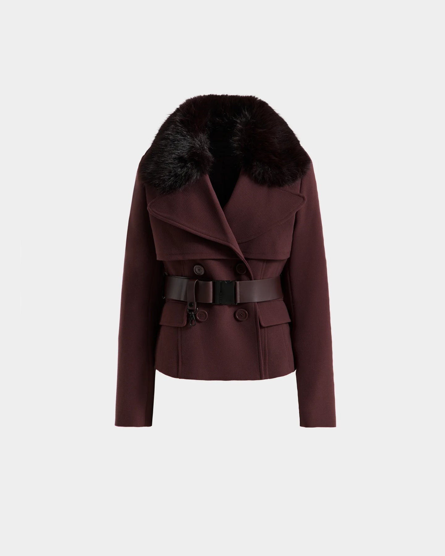 The Rudsak LINDSAY - 8125538 Bordeaux is a double-breasted women’s burgundy transitional coat featuring a wide black faux fur collar, vegan leather belt, and flap pockets, shown on a plain white background.
