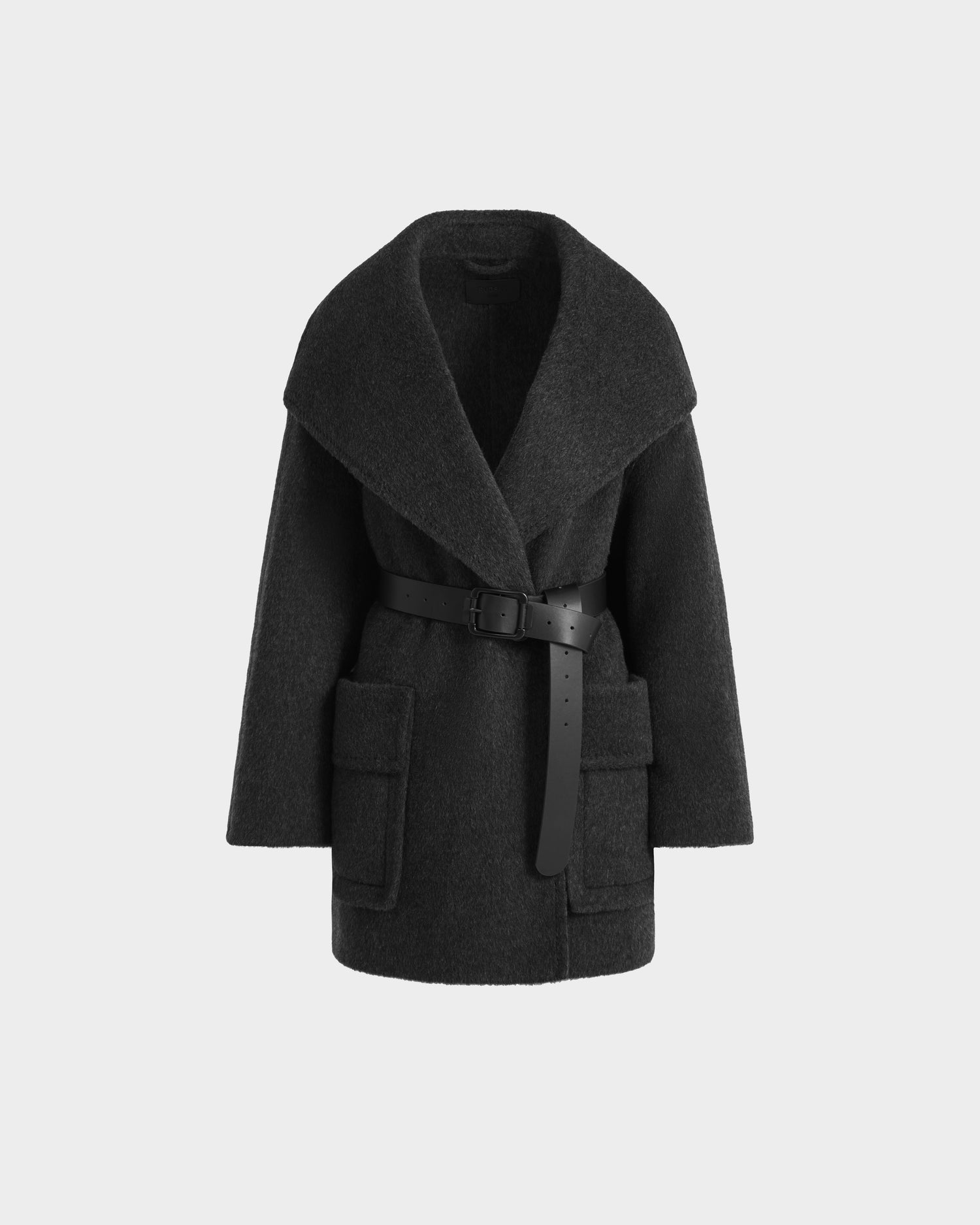 The Rudsak LUCIA - 8125633 Heather Black is a dark gray women’s wool jacket with wide lapels, a removable vegan leather belt, large patch pockets, and an oversized fit, shown against a plain white background.