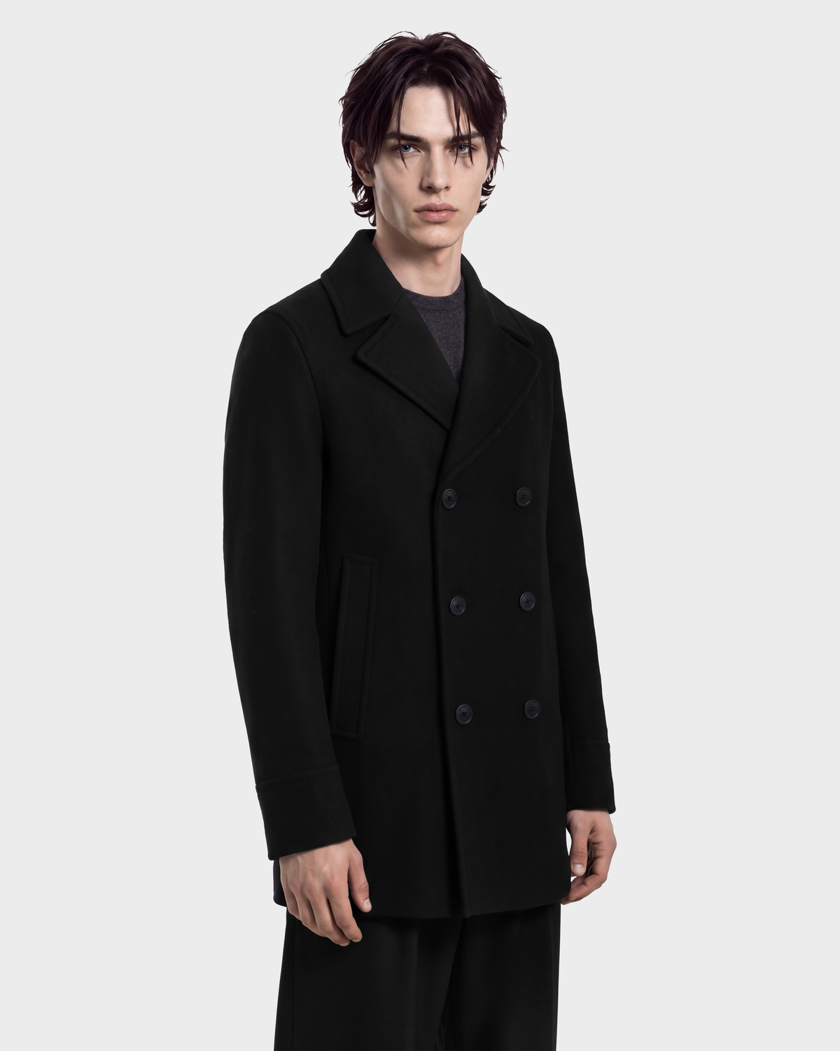A man wearing a black Rudsak LUCIEN - 6126508 double-breasted pea coat over a dark grey sweater.