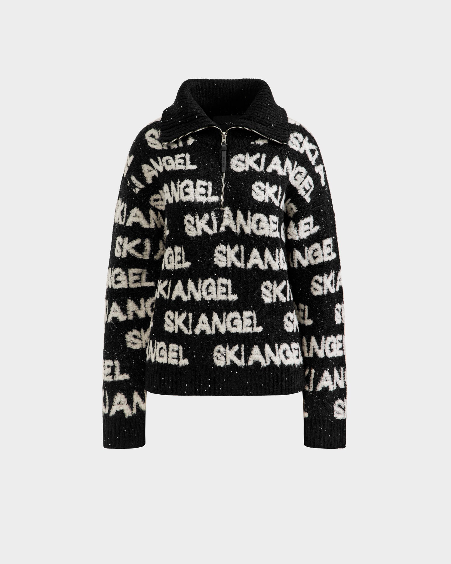 The LYDIA - 8525687 Black by Rudsak is a black and white fuzzy winter knit women’s sweater with a zip-up collar and bold SKIANGEL print, offering cozy après-ski style. Displayed on a plain white background.