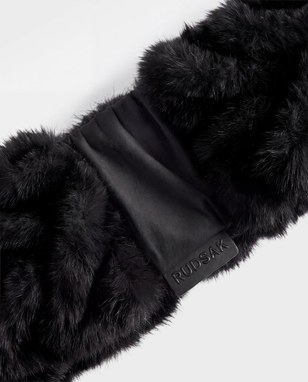 Black Rudsak MILA - 8426518 faux fur scarf with a central fabric band and a small branded logo tab.