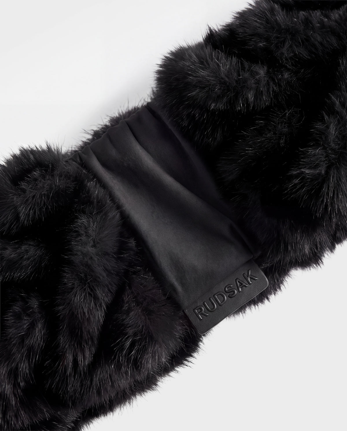 Black Rudsak MILA - 8426518 faux fur scarf with a central fabric band and a small branded logo tab.