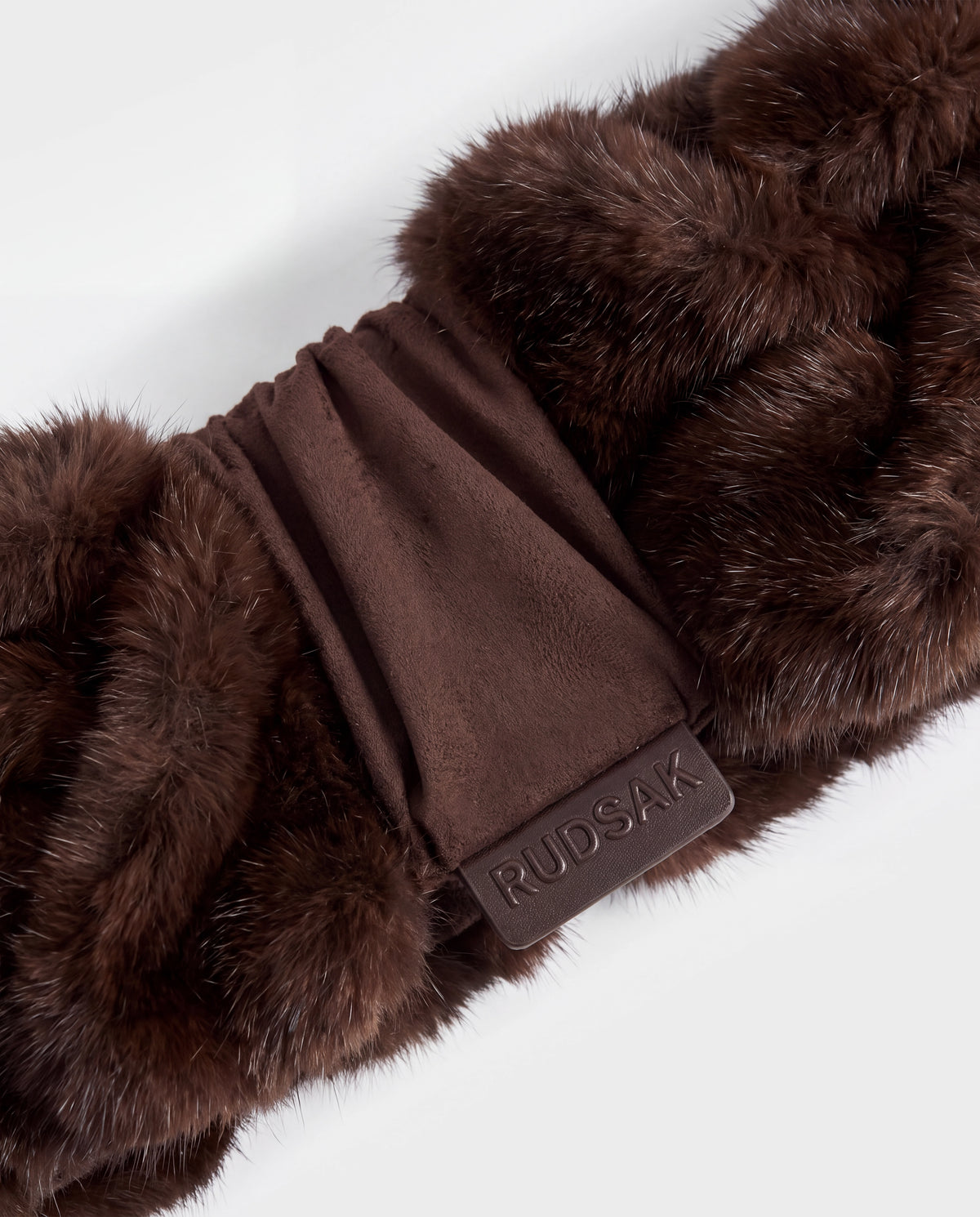 Rudsak MILA - 8426518 Espresso dark brown fur scarf with a central suede section and a rectangular leather tag embossed with the brand name.