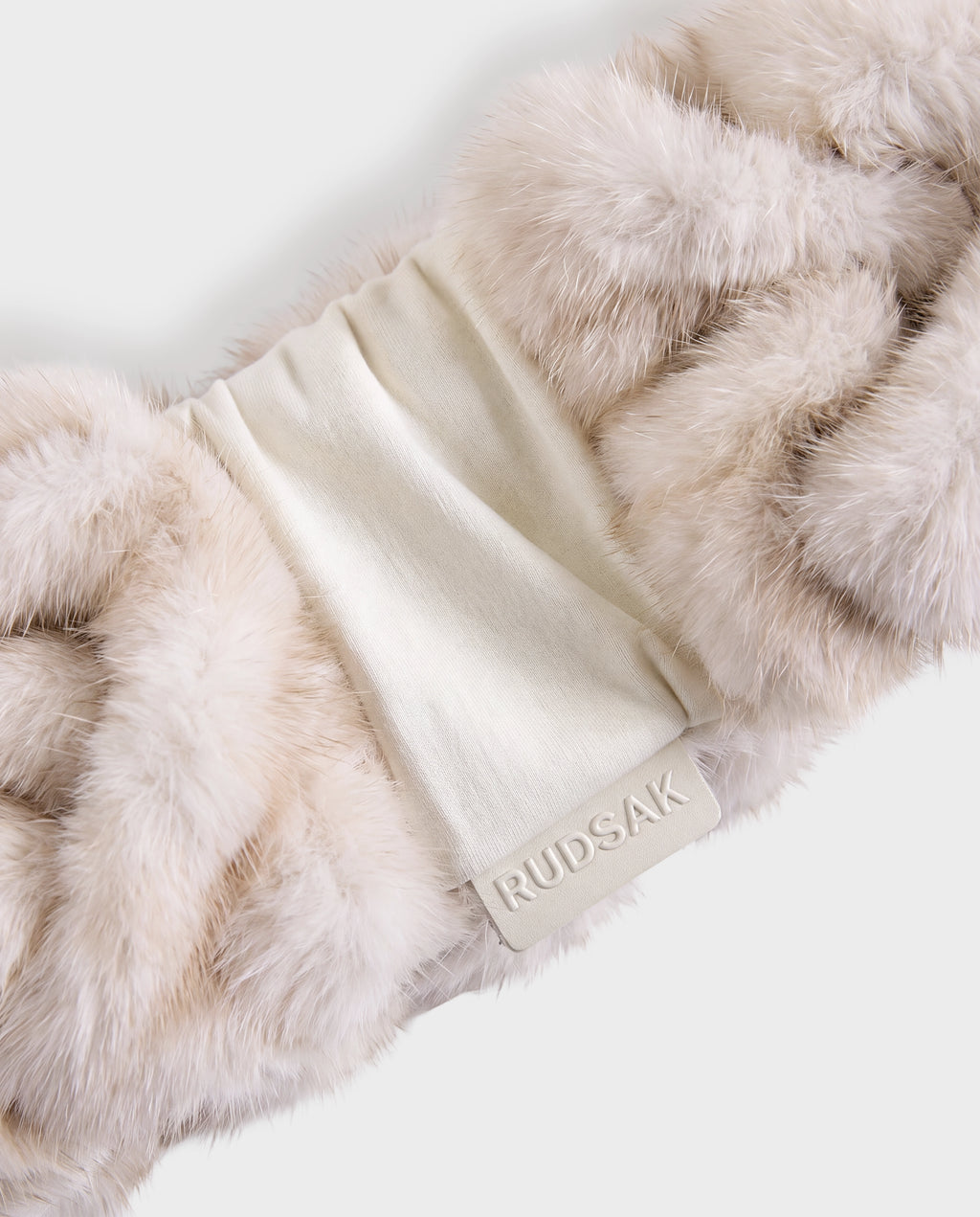 Off-white RUDSAK MILA - 8426518 Vanilla fur headband with a matching fabric center panel featuring an embossed brand logo tag.