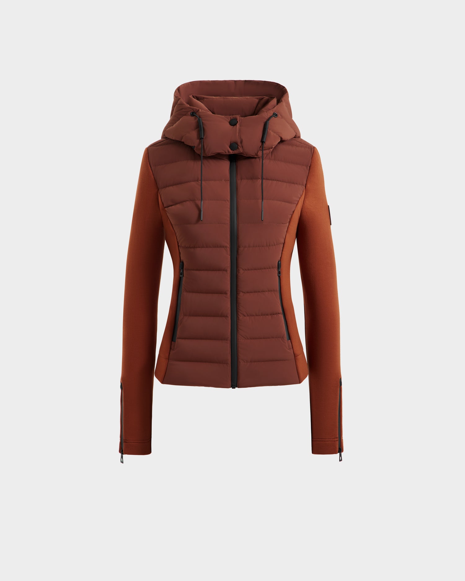 The Rudsak MABS - 8125055 Rust is a rust-colored, fitted women’s puffer jacket with padded front, zippered closure, hood, and zippered long sleeves—ideal as lightweight activewear. Shown on a plain white background.