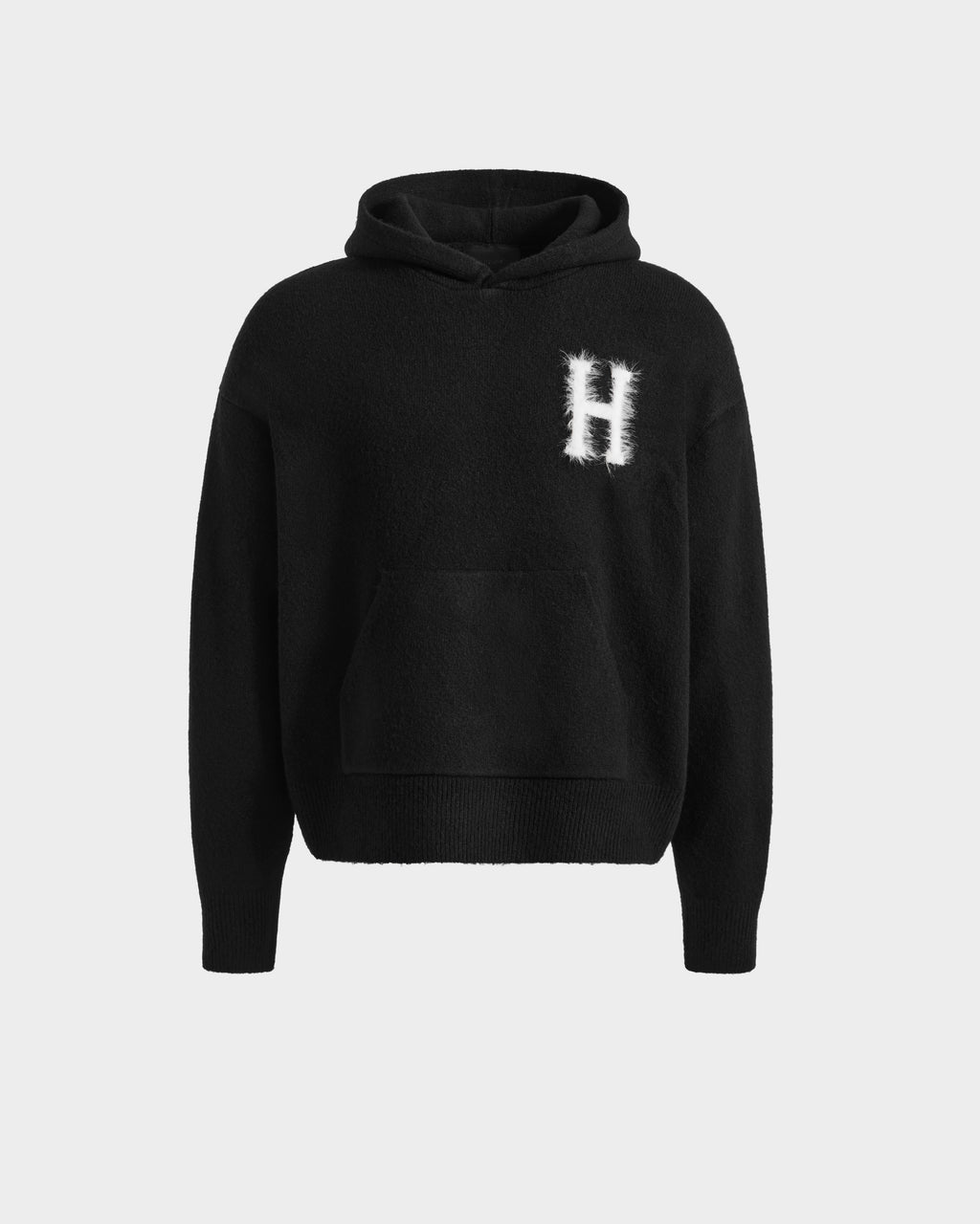 The Rudsak MARCUS HV - H525503 Black hoodie features a kangaroo pocket and a white, fuzzy letter H on the left chest, blending classic collegiate style with modern design. Displayed against a plain light background.