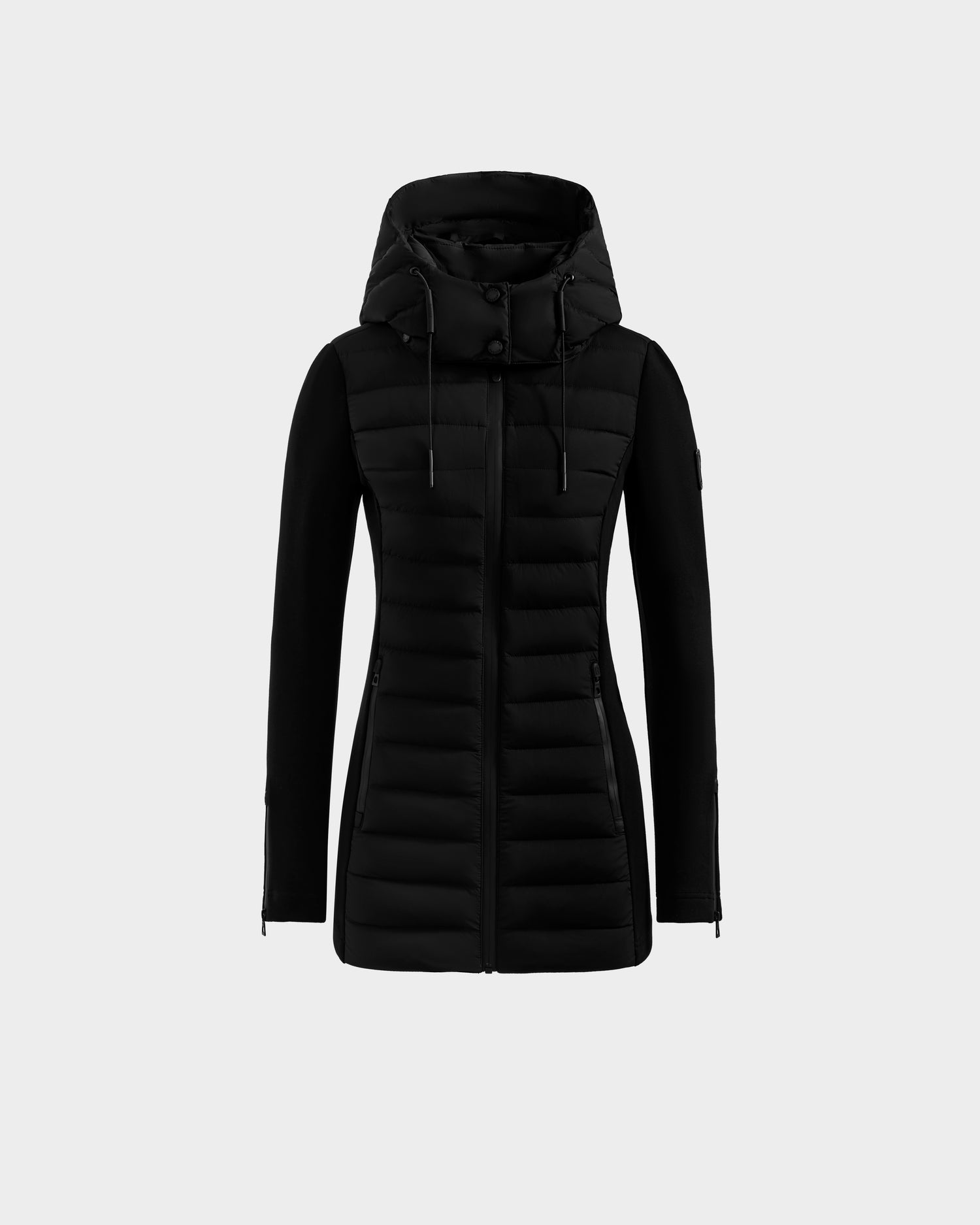 The Rudsak MARRY M - L125519 Black is a women’s hybrid jacket with long sleeves, a hood, front zipper, light down warmth, and horizontal body quilting, shown on a plain white background.