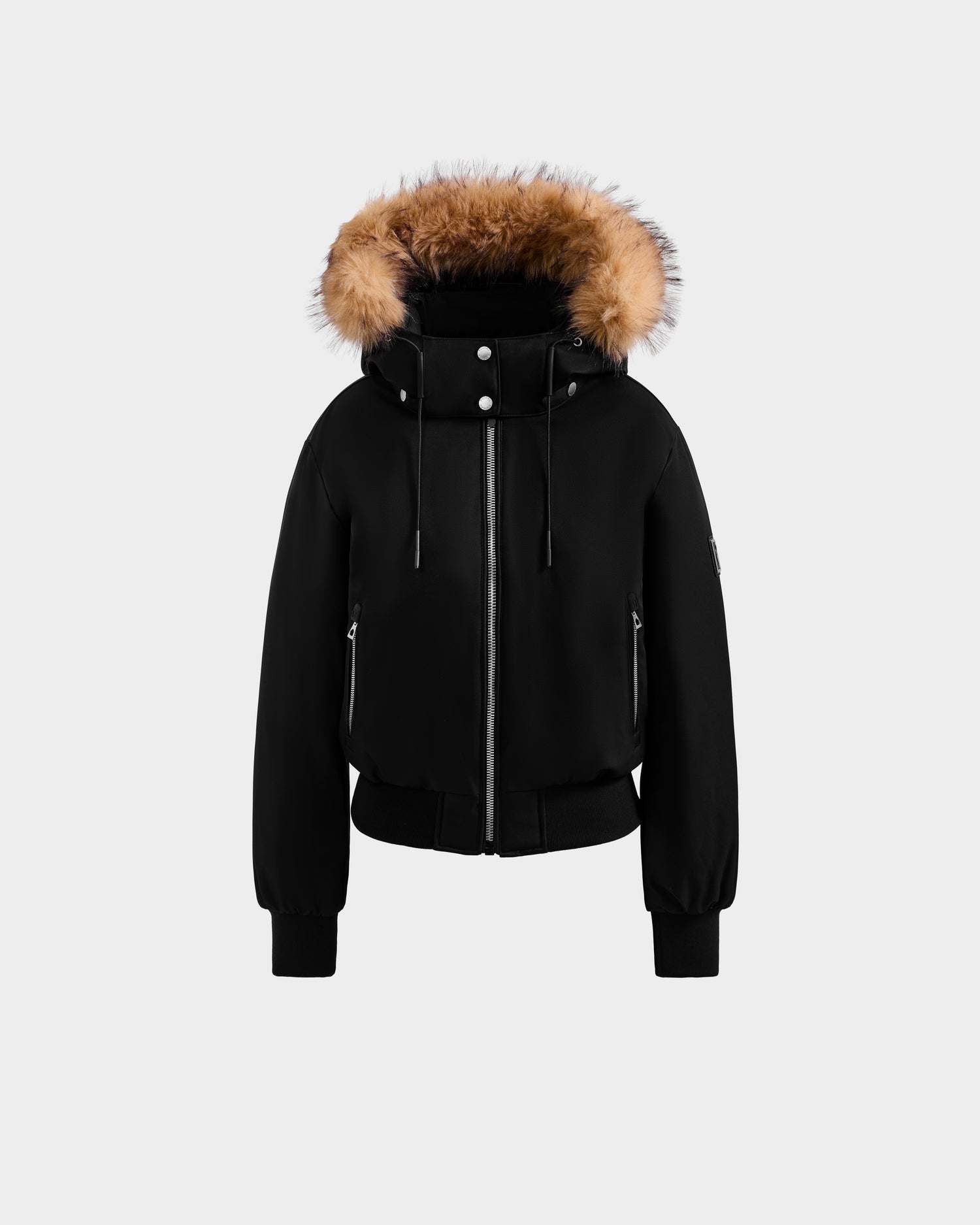 The Rudsak MAUDE - L124522 Black/Natural jacket features urban chic style with a front zipper, silver buttons, and a brown faux fur-trimmed hood, shown on a plain light gray background.
