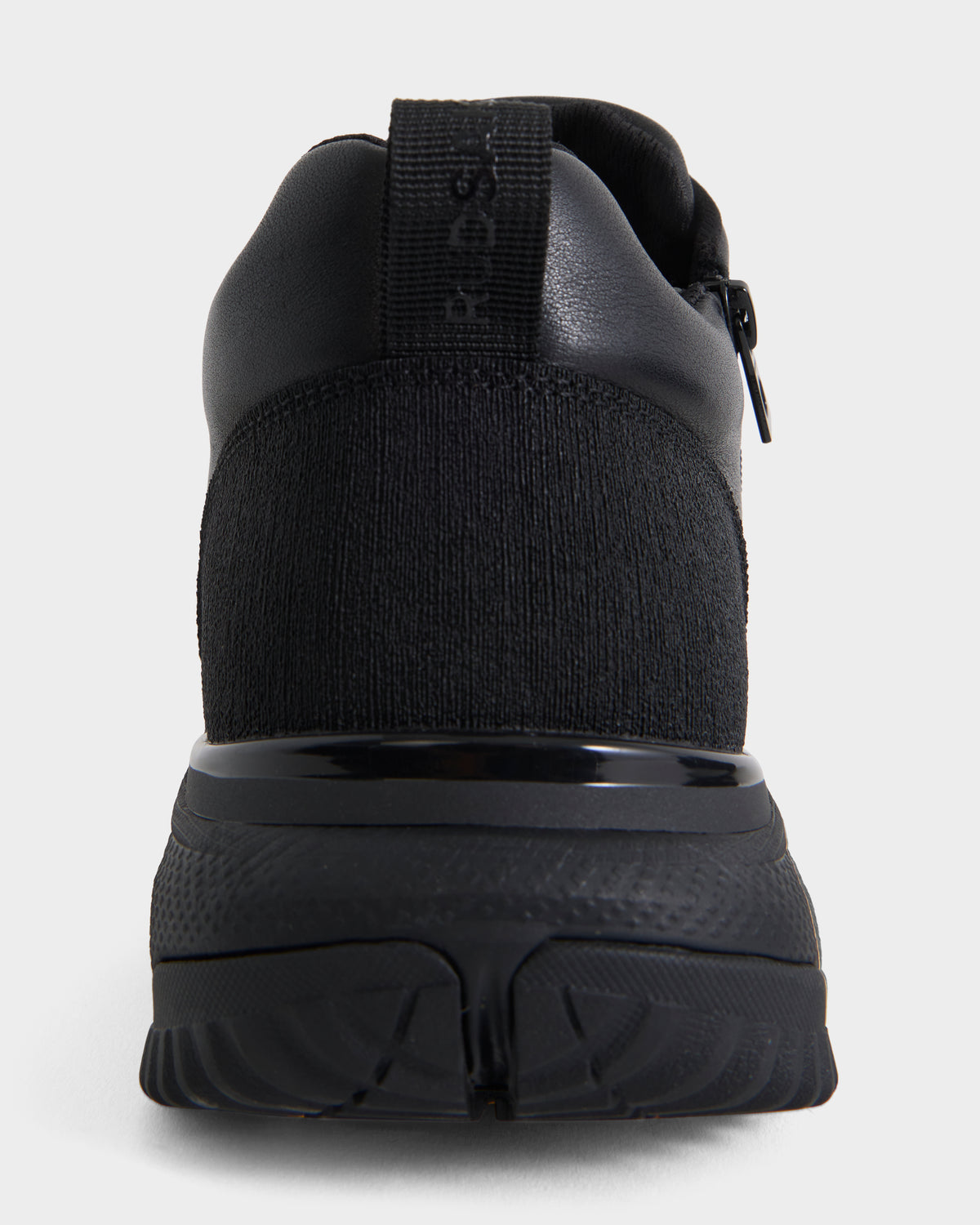 A close-up rear view of the Rudsak MAX - 6226502 Black men’s sneaker highlights its athletic style with a textured knit upper, rubber sole, and heel pull tab.
