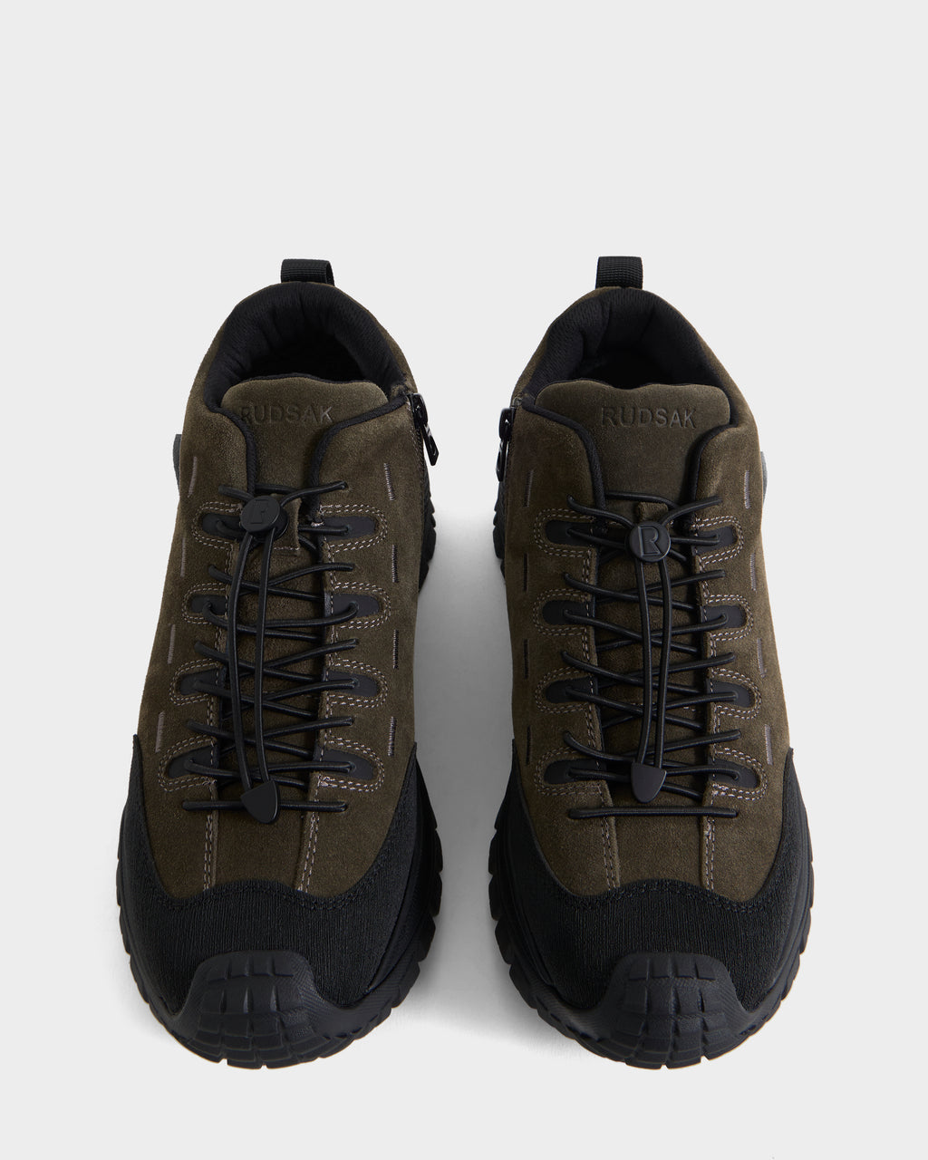 A pair of Rudsak MAX S - 6226505 Olive sneakers in dark green and black suede, featuring thick rubber soles and lace-up fronts, viewed from above on a white background.
