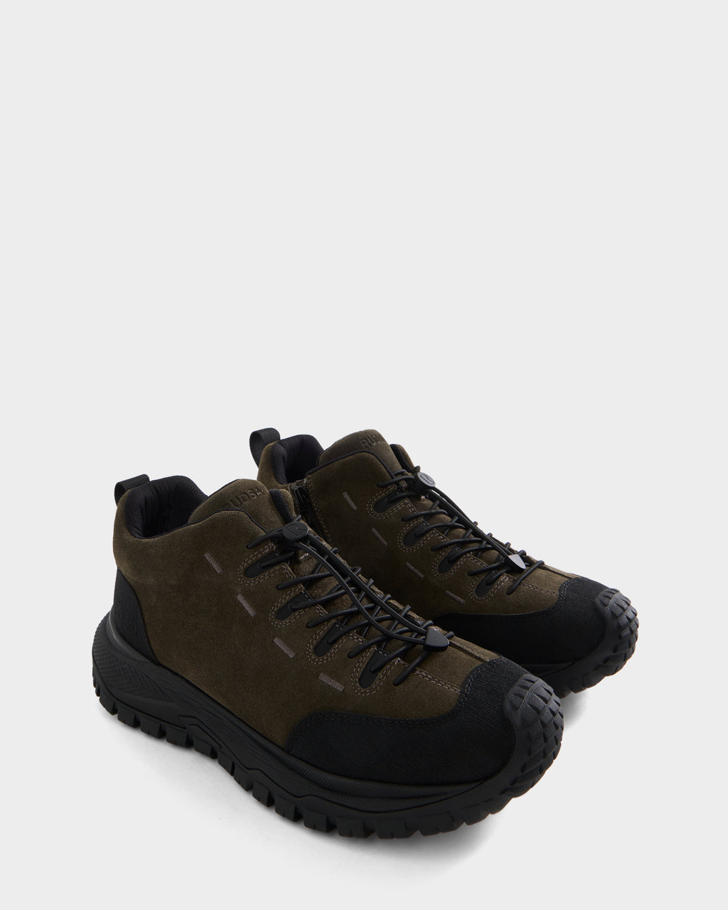 A pair of Rudsak MAX S - 6226505 Olive trail-inspired sneakers in dark green and black with thick rubber soles and black laces, displayed on a light gray background.