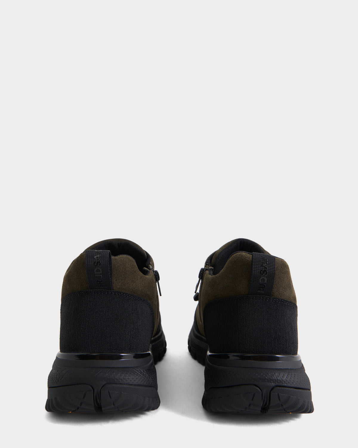A pair of Rudsak MAX S - 6226505 Olive men’s sneakers in black and dark olive suede, shown from the back against a plain white background.