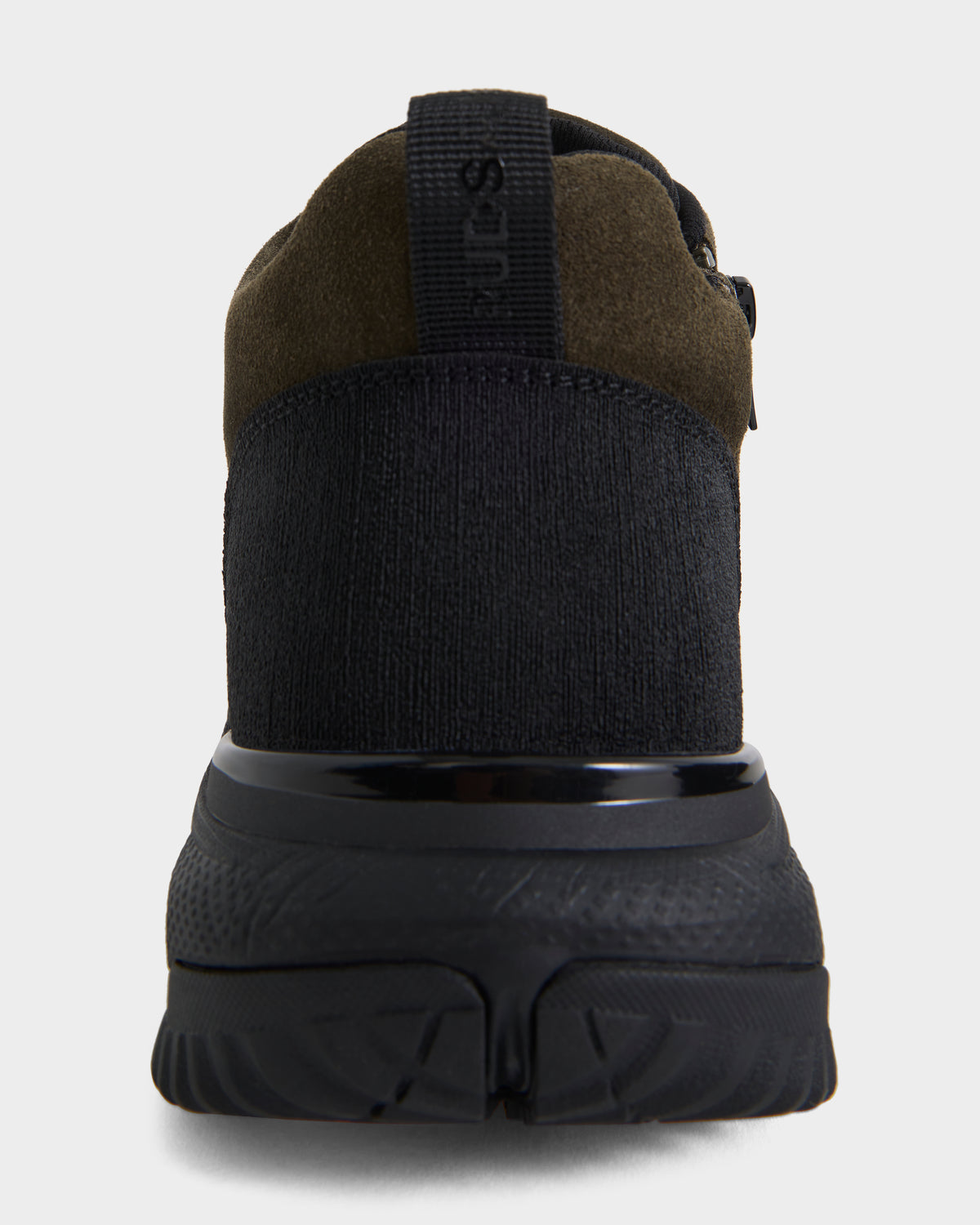 A rear view of the Rudsak MAX S - 6226505 Olive sneaker in black and dark olive, featuring a textured sole, heel pull tab, and the Rudsak logo embossed on the back strap.