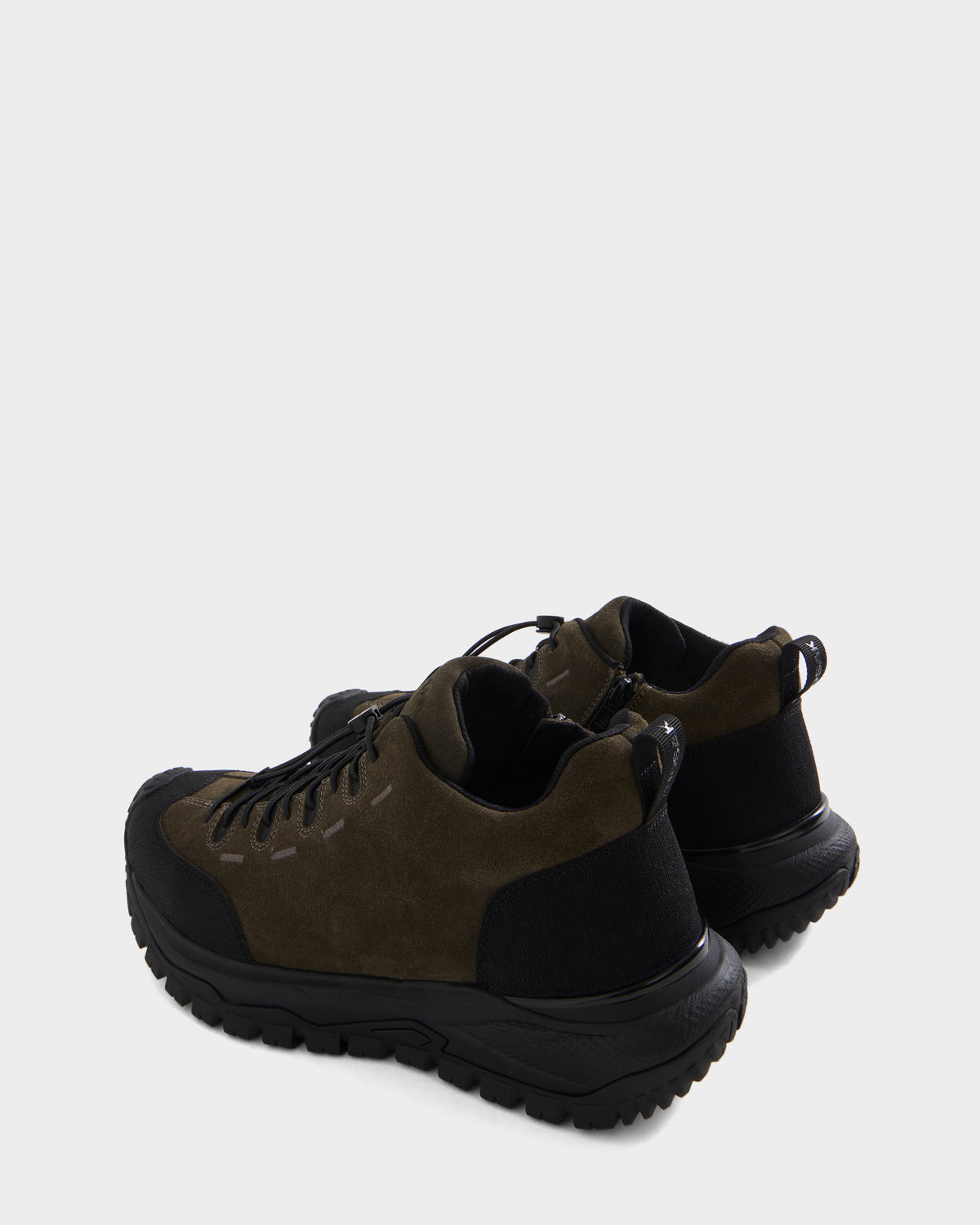 A pair of Rudsak MAX S - 6226505 Olive trail-inspired suede sneakers with black soles and black heel accents, displayed on a light gray background and positioned to showcase the back and side of the shoes.