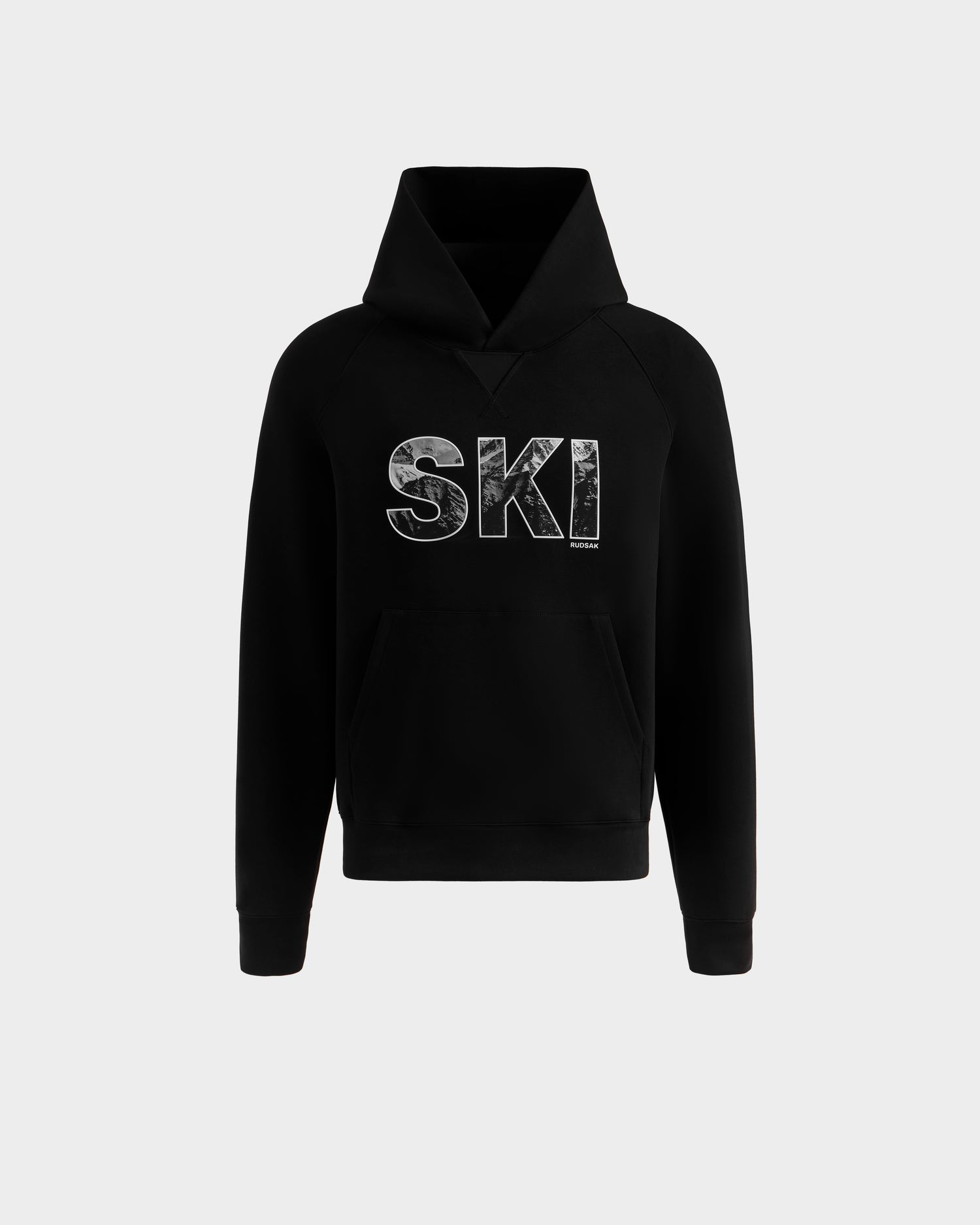 The Rudsak MIKAEL - 6525647 Black men's ski hoodie features a front pocket and bold, textured white "SKI" lettering on the chest, shown on a plain gray background—ideal for winter sports or keeping warm.