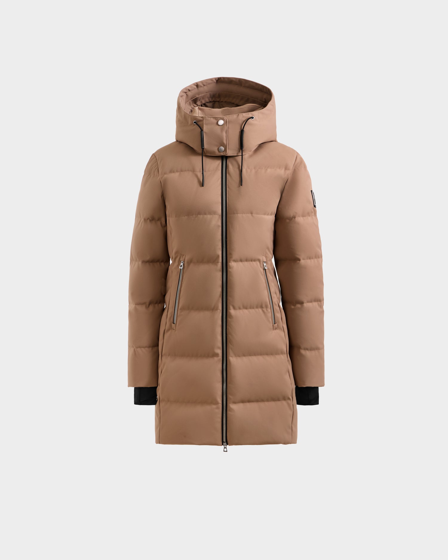 The Rudsak MIRIAM - L123544 Sand is a long tan women's down puffer coat with a hood, black zipper front, two zippered side pockets, and black inner cuffs, made from RDS-certified down, shown against a plain white background.