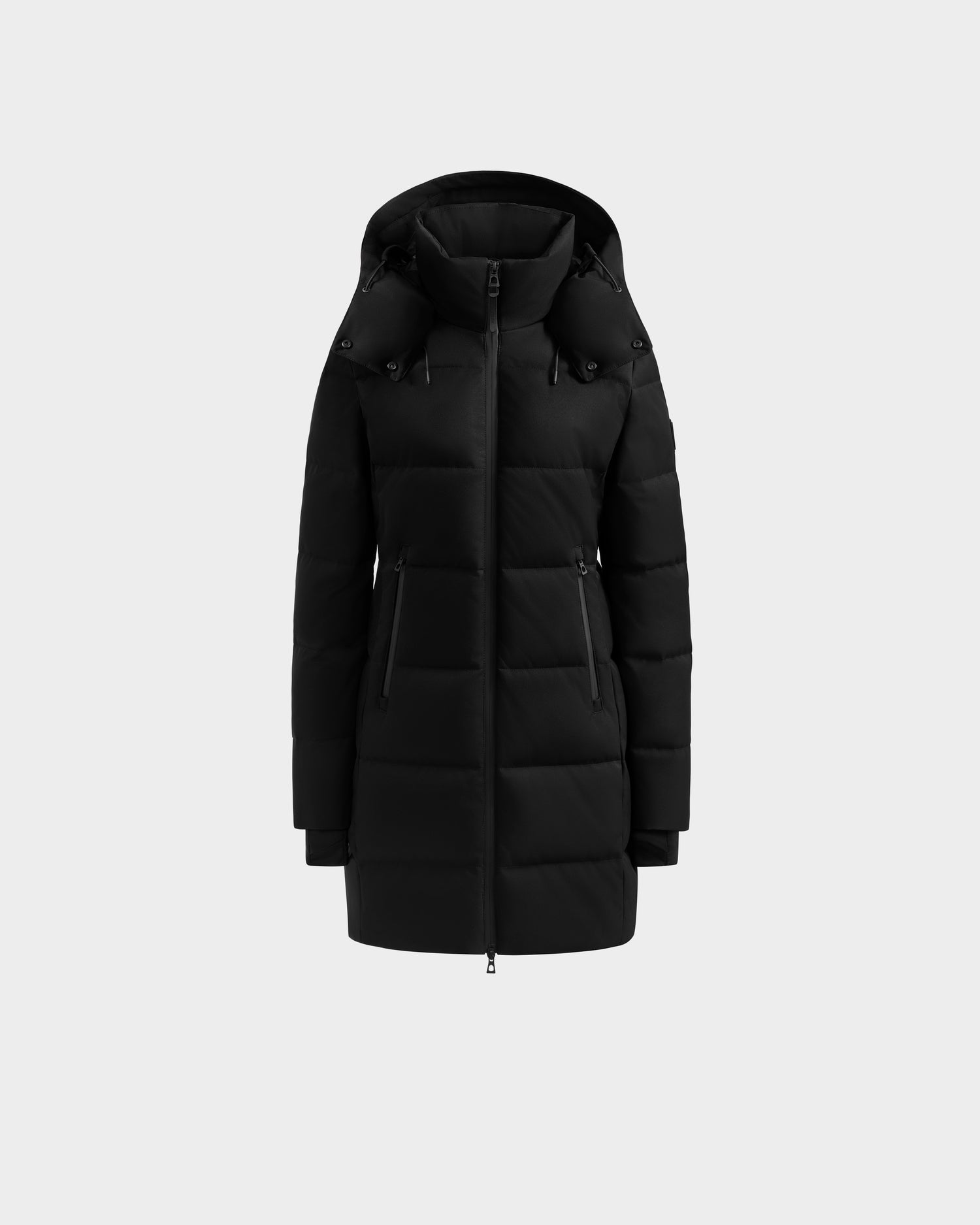 The Rudsak MIRIAM MW - L125604 Black is a knee-length women’s down puffer jacket with a hood, front zipper, and two zippered side pockets. Crafted with RDS-certified down, it’s shown on a light gray background—ideal for your winter wardrobe.