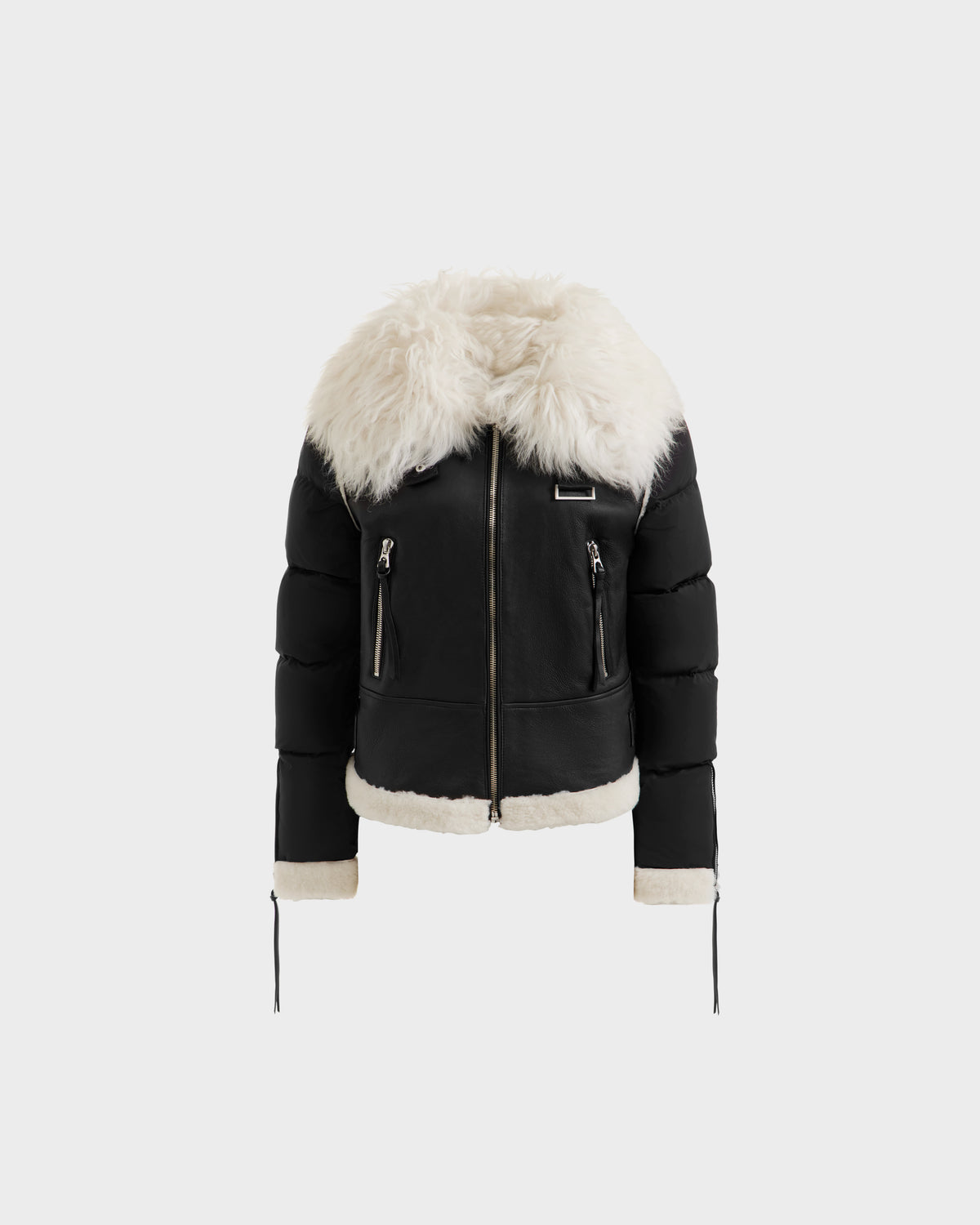 The Rudsak MONKA - 8125629 Black puffer jacket features a Mongolian shearling collar and trim, front zip closure, and zippered pockets for lightweight warmth. Shown on a plain white background.