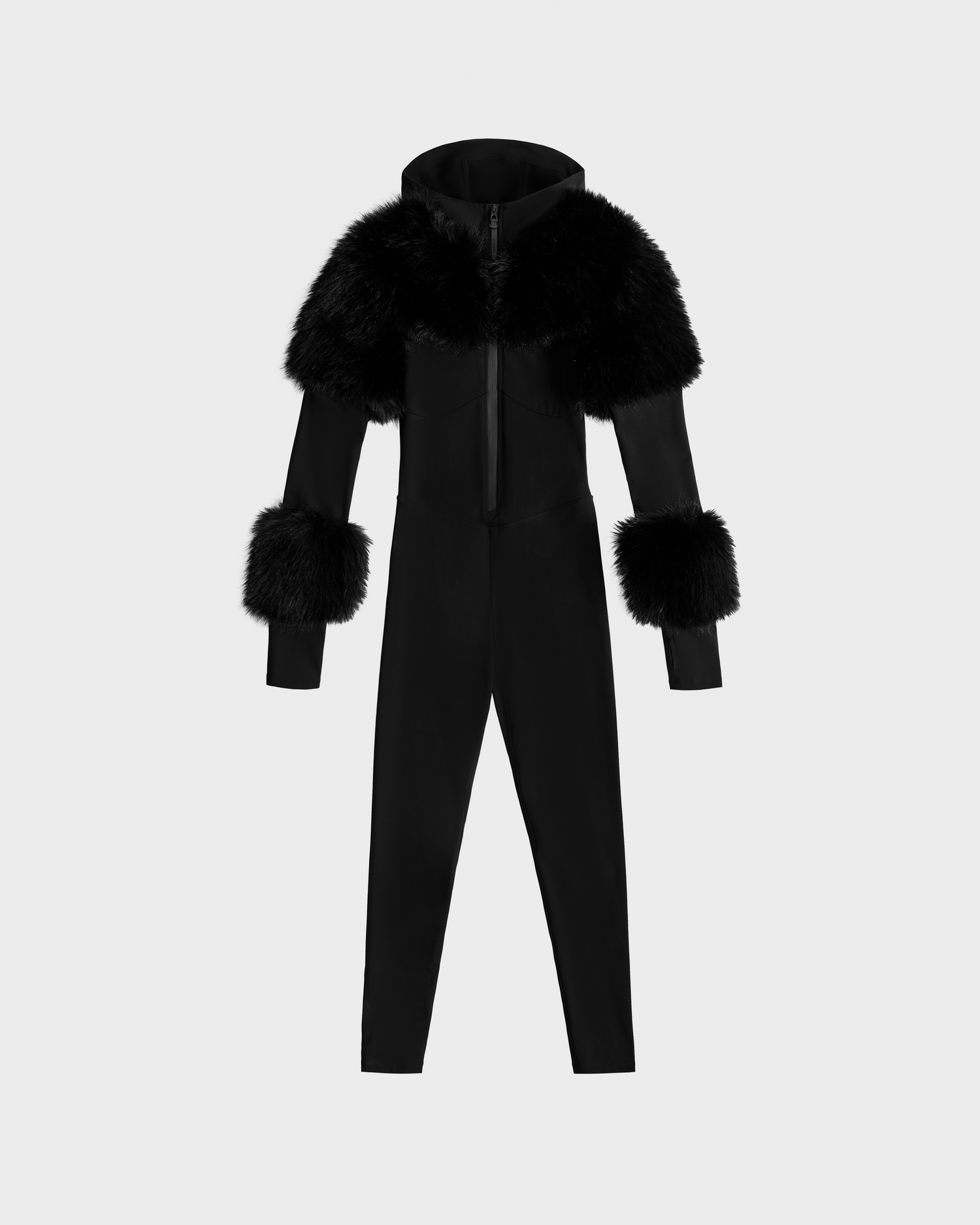 The Rudsak MYLA - 8525671 Black is a women's full-length, hooded bodysuit with large faux fur trim on the shoulders and cuffs, ideal for winter style. Shown here on a plain light gray background.