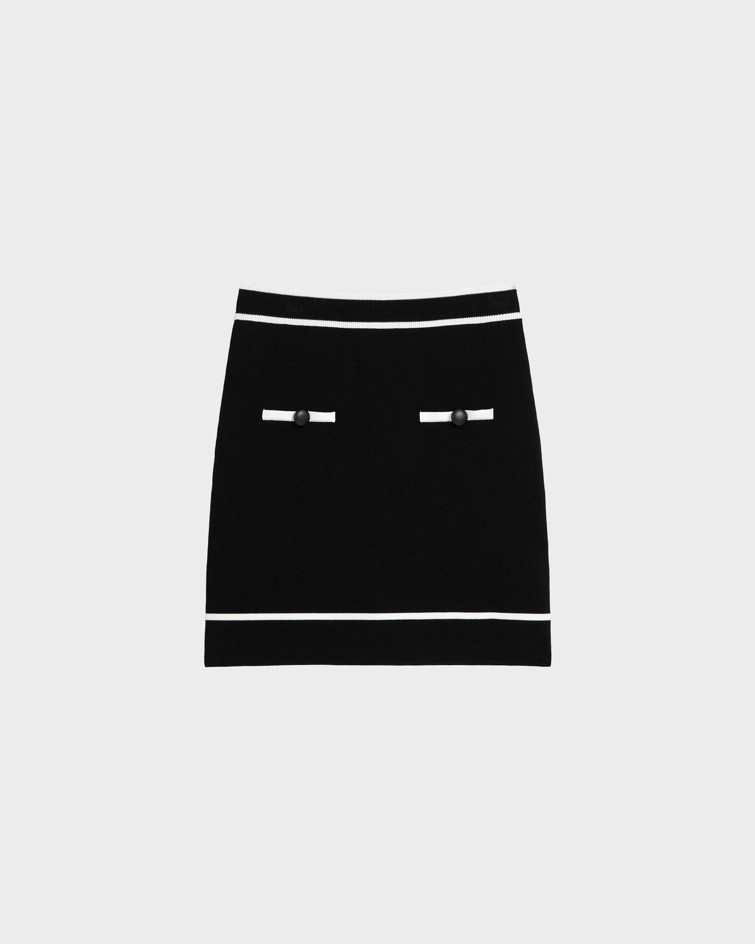 The Rudsak NAPA - 8525083 Black mini skirt features white stripes on the waistband and hem, two front decorative pockets with white trim and black buttons, all set against a plain light background.