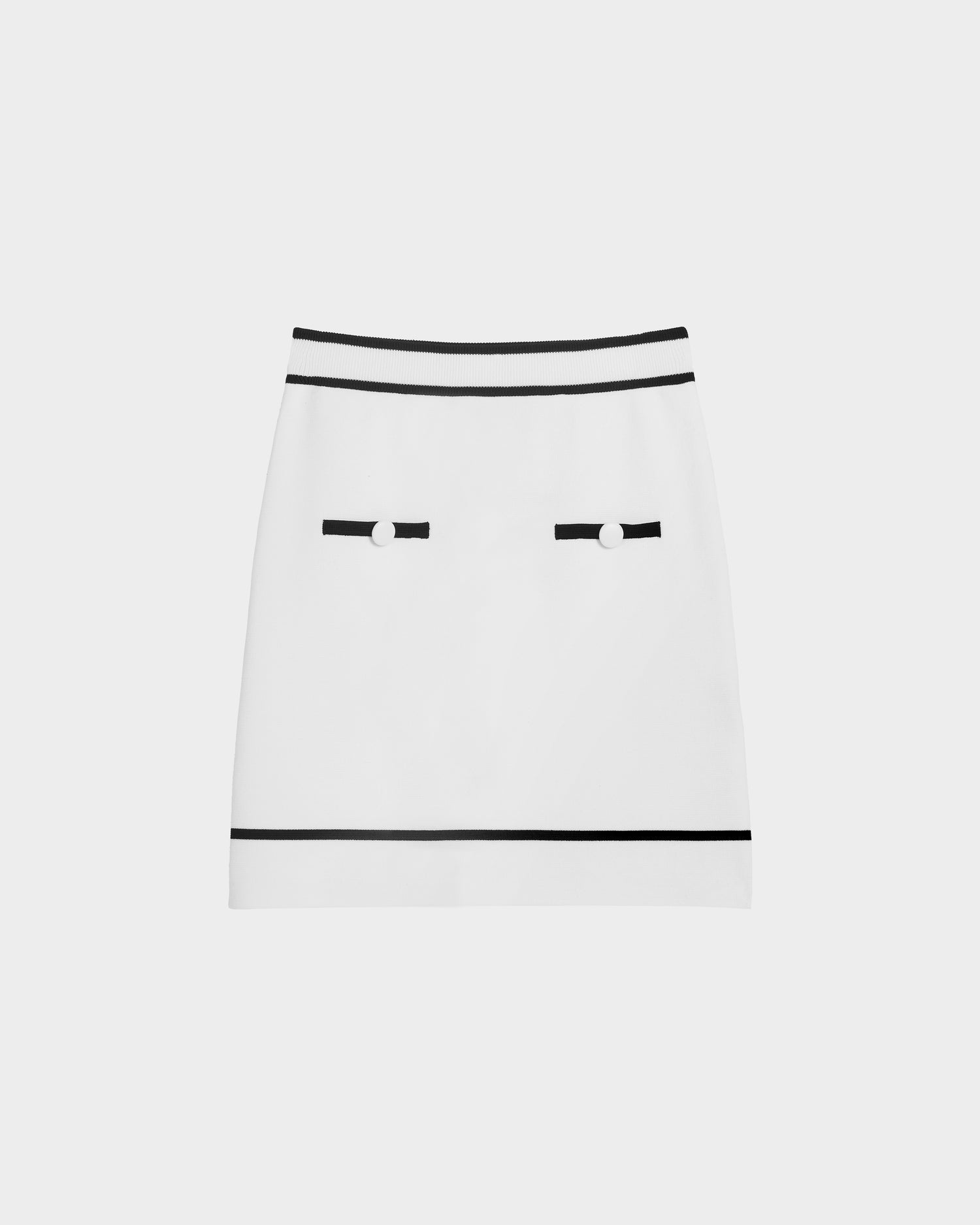 The Rudsak NAPA - 8525083 Optic White women’s fitted knit mini skirt in white features black trim at the waistband and hem, two decorative black straps with buttons near the front pockets, and is shown on a plain white background.