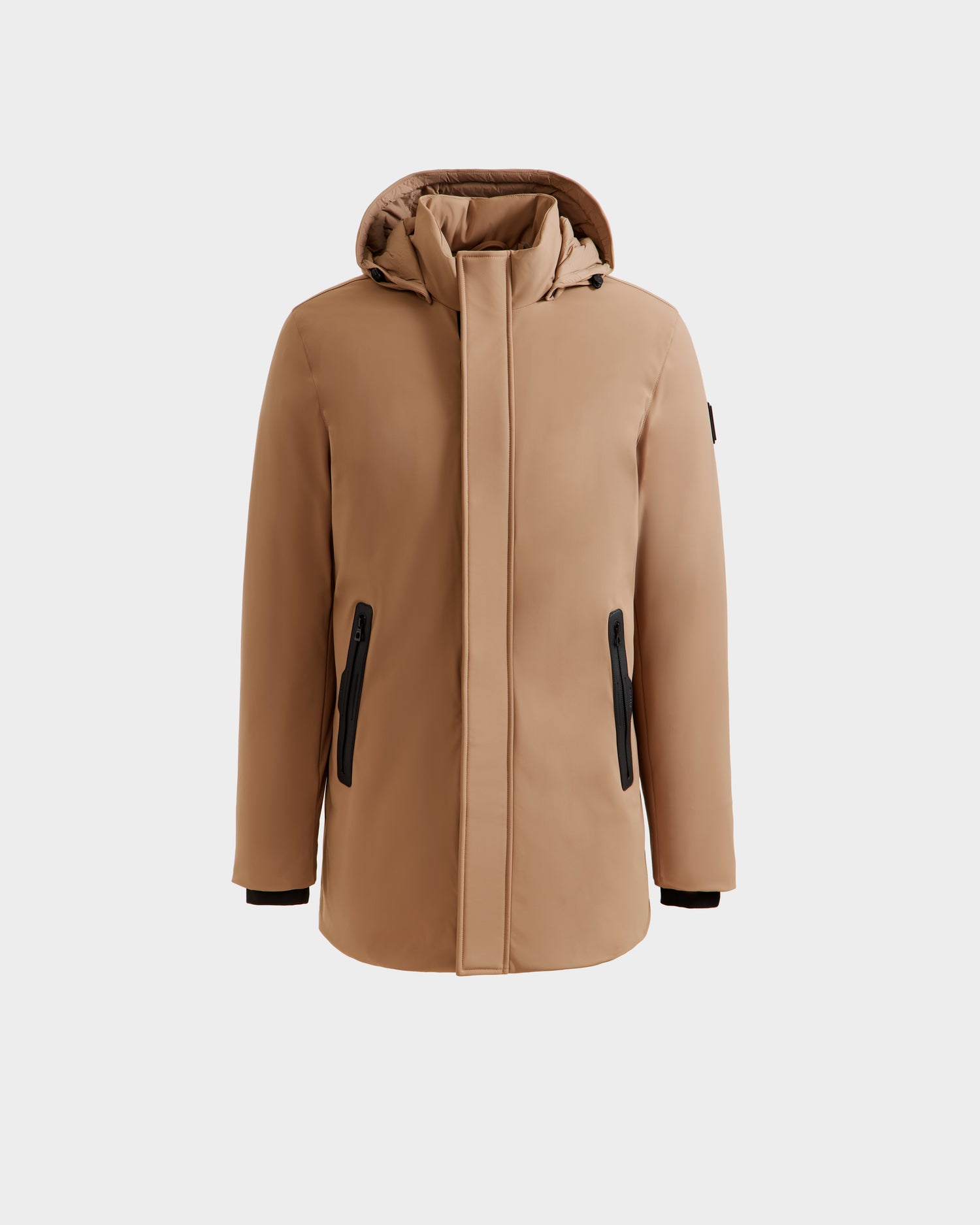 The Rudsak NATAN - M124519 Sand is a tan hooded winter coat with a front zipper, black zippered side pockets, long sleeves, and down fill insulation, shown against a plain white background.